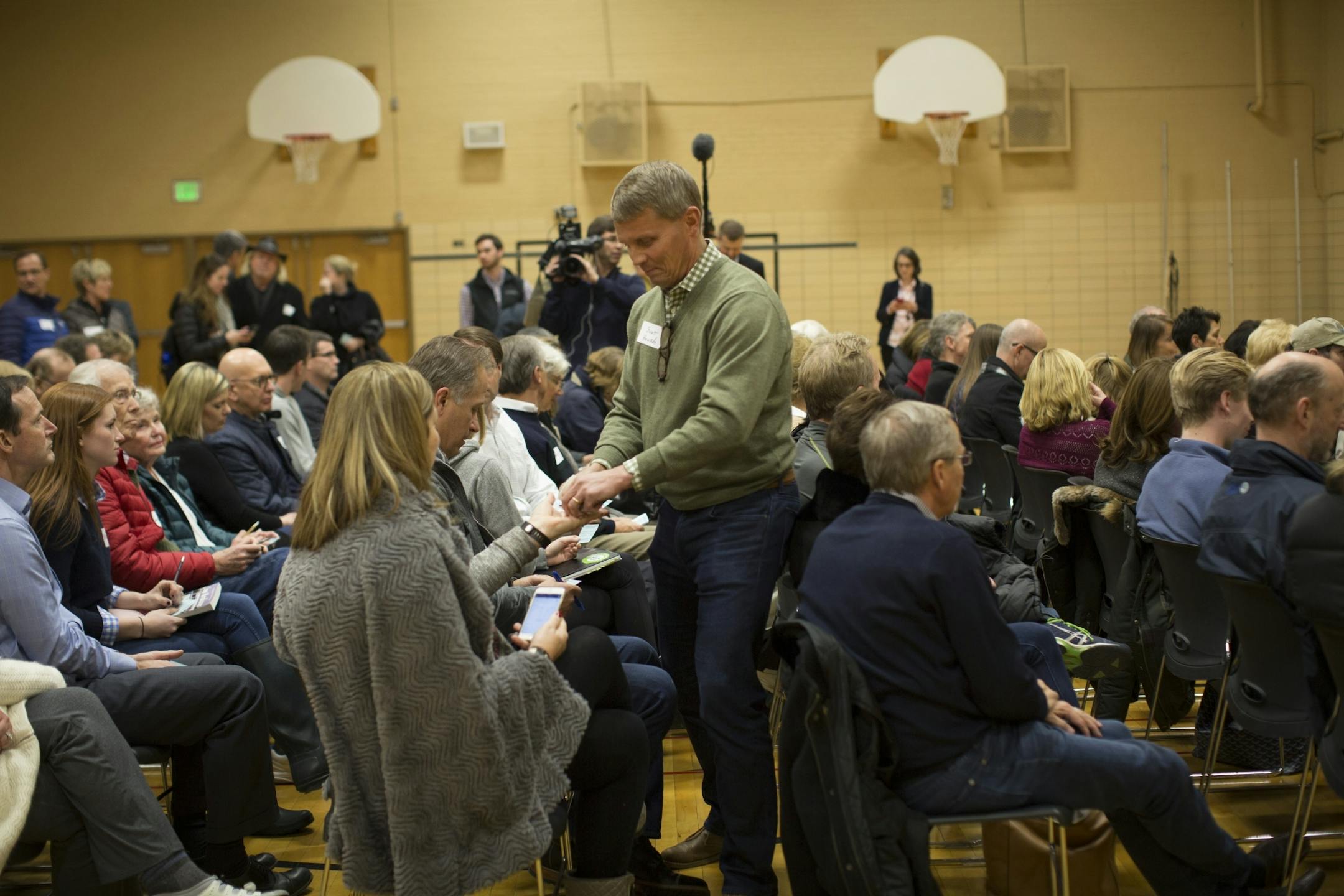 Scot Housh collected ballots after voting during a GOP precinct caucus for precinct 3 at South View Middle School on March 1, 2016, in Edina, Minn.