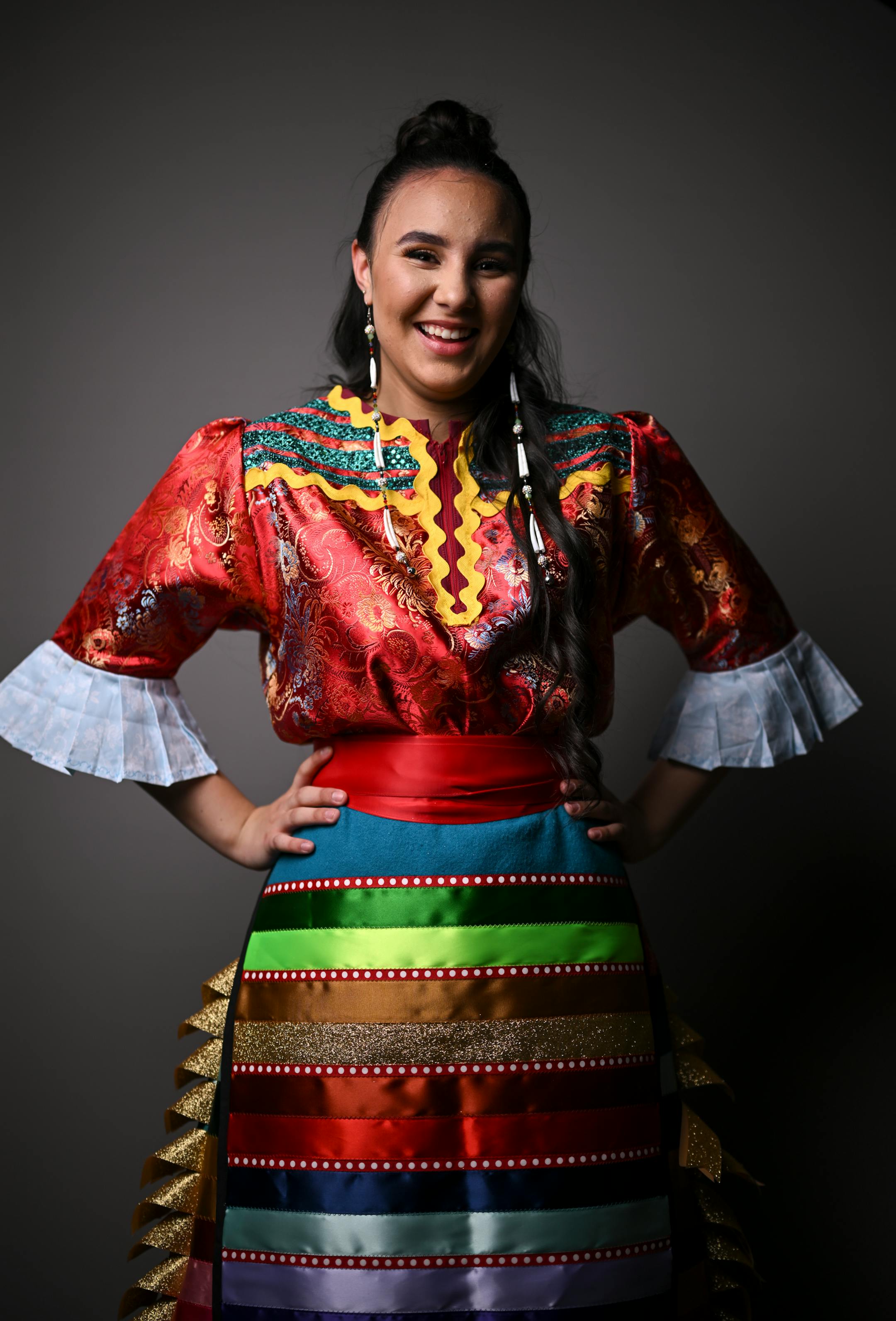 Ariahana Schjenken, with the Leech Lake Band of Ojibwe, stands for a portrait during "Northern Lights: A Native Nations Fashion Night." Schjenken is wearing designs by artist Lavender Hunt.