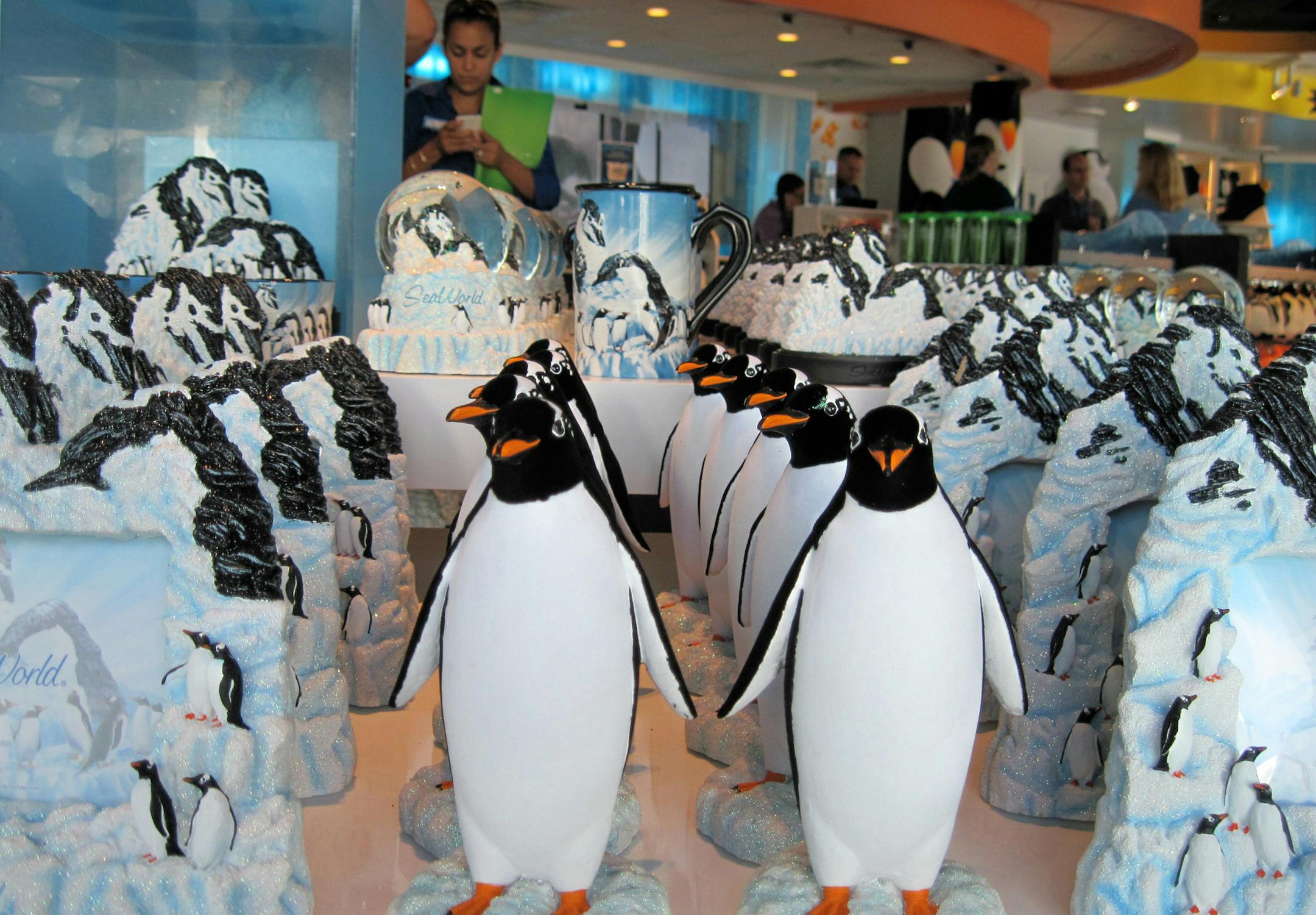 Photo by: Peter Mandel, (401) 831-5227 Caption info: Penguins, and more penguins. The gift shop at SeaWorld‚Äôs ‚ÄúAntarctica: Empire of the Penguin‚Äù has cornered the market on them, with rack after rack of logo gear, toys, books and stuffed versions.
