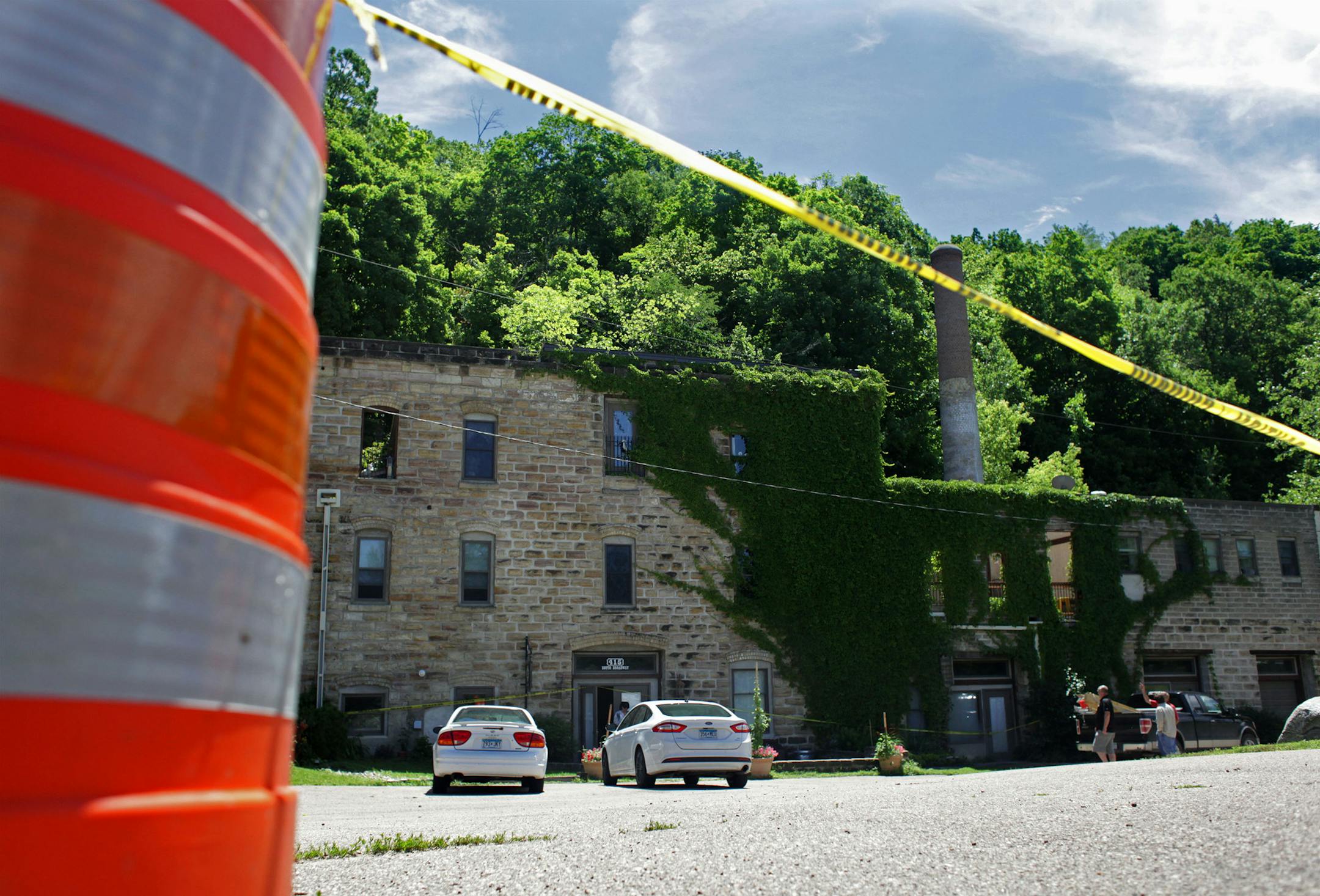 Yellow tape and orange cones block off the parking lot of the historic Jordan Brewery after a mudslide severely damaged the building two weeks ago. ] MONICA HERNDON monica.herndon@startribune.com Jordan, MN 07/2/2014