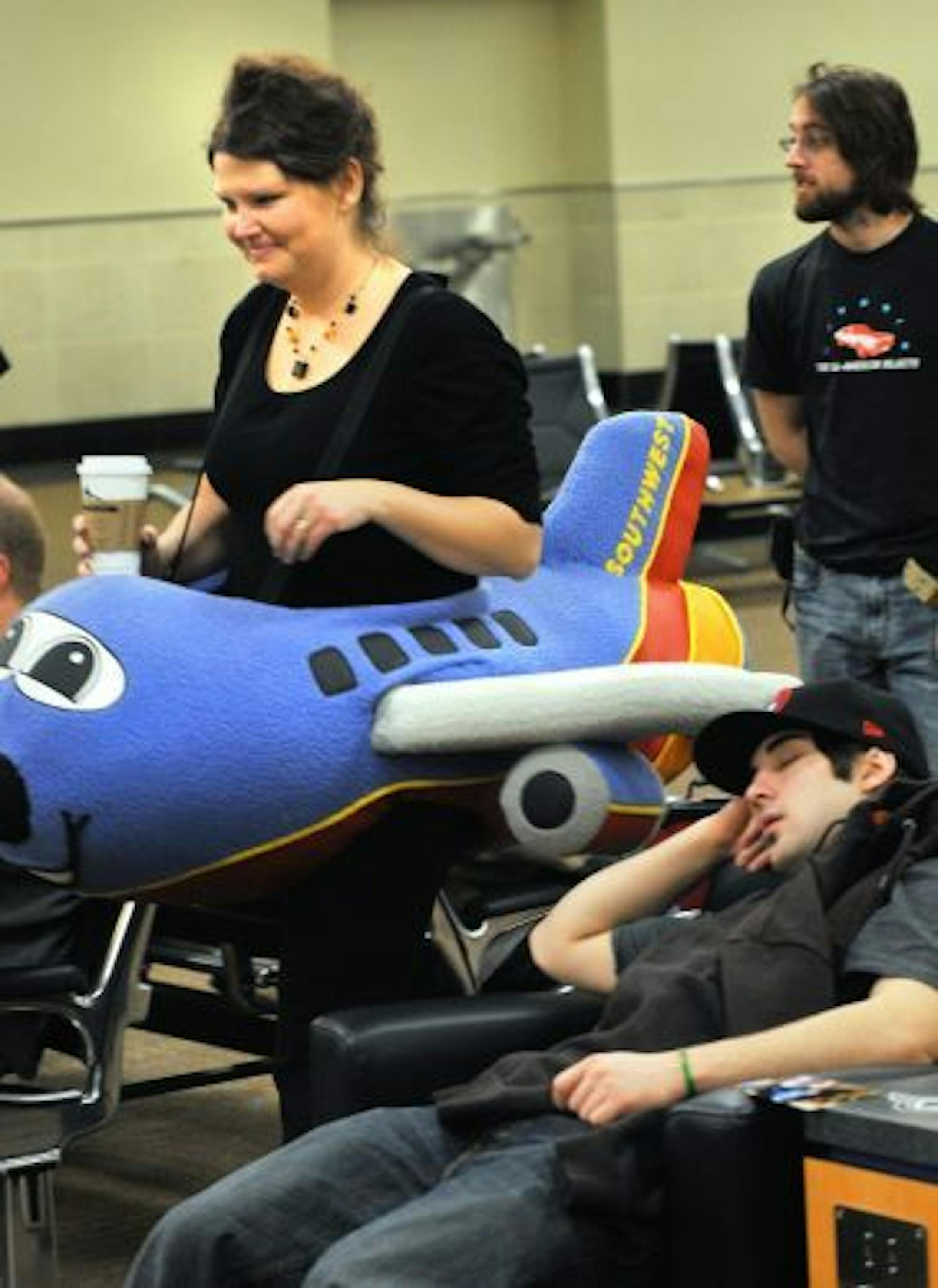 Natosha Livengood, wearing a puffy Southwest Airlines jet handed out sticks of spearmint lip balm to waiting passengers.