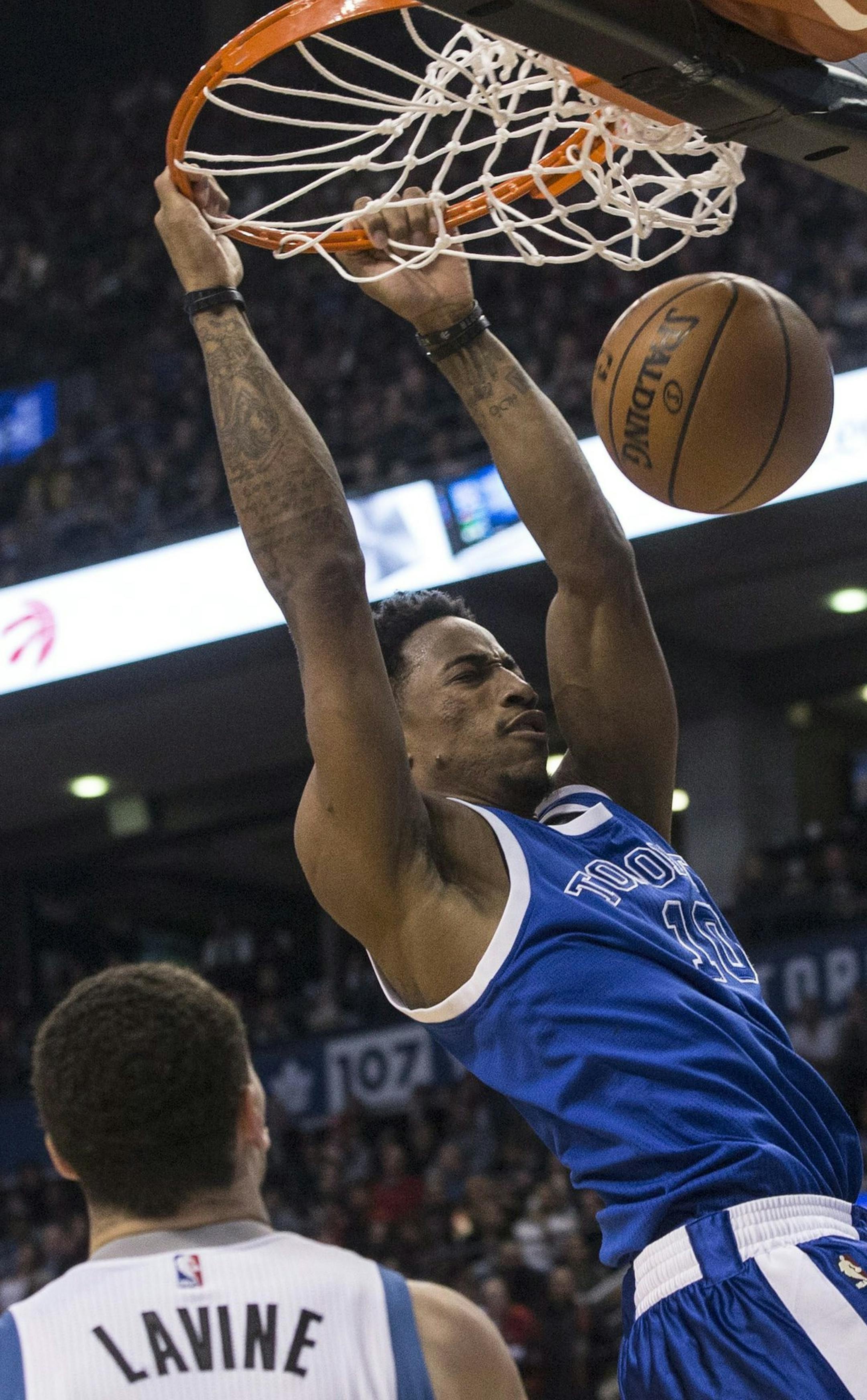 Toronto Raptors guard DeMar DeRozan, right, scores on Minnesota Timberwolves guard Zach LaVine during the first half of an NBA basketball game in Toronto on Thursday, Dec. 8, 2016. (Chris Young/The Canadian Press via AP)