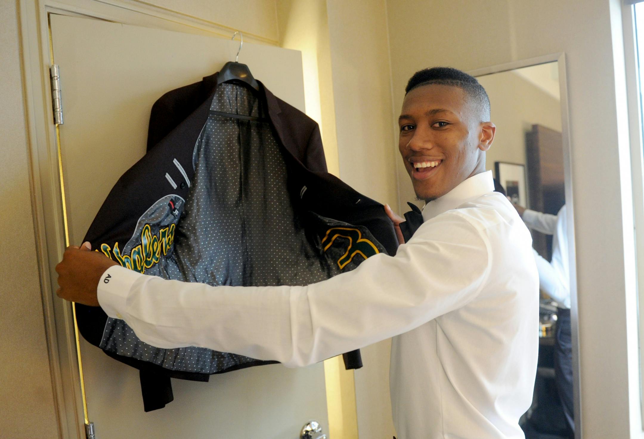 Top NBA pick Kris Dunn gets ready for the draft, wearing JF J. Ferrar only at JCPenney, Thursday, June 23, 2016, in New York. The liner was custom-made with a patch from his high school jersey and fabric with his college colors. Dunn was selected by the Minnesota Timberwolves in the first round of the 2016 NBA Draft.