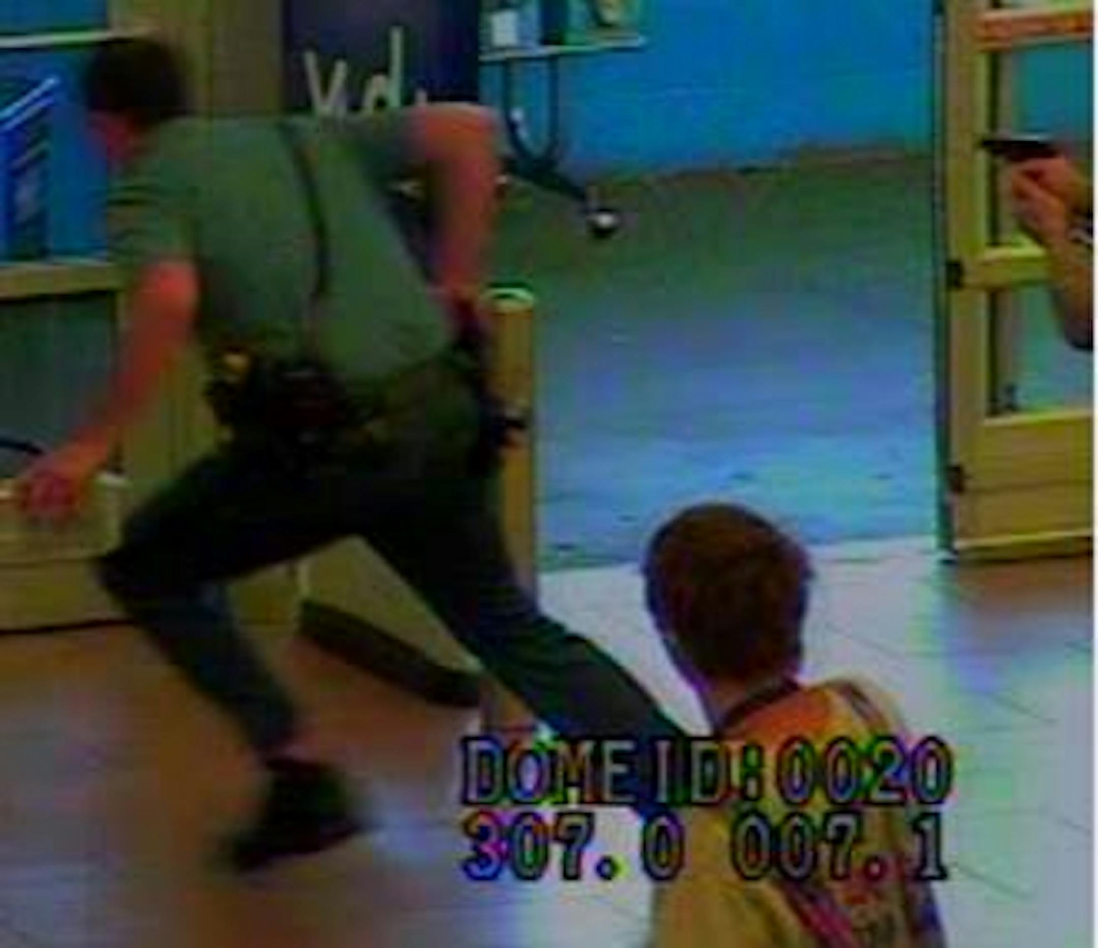 The officer pursues the suspect in another scene from surveillance footage at a St. Paul Wal-Mart.