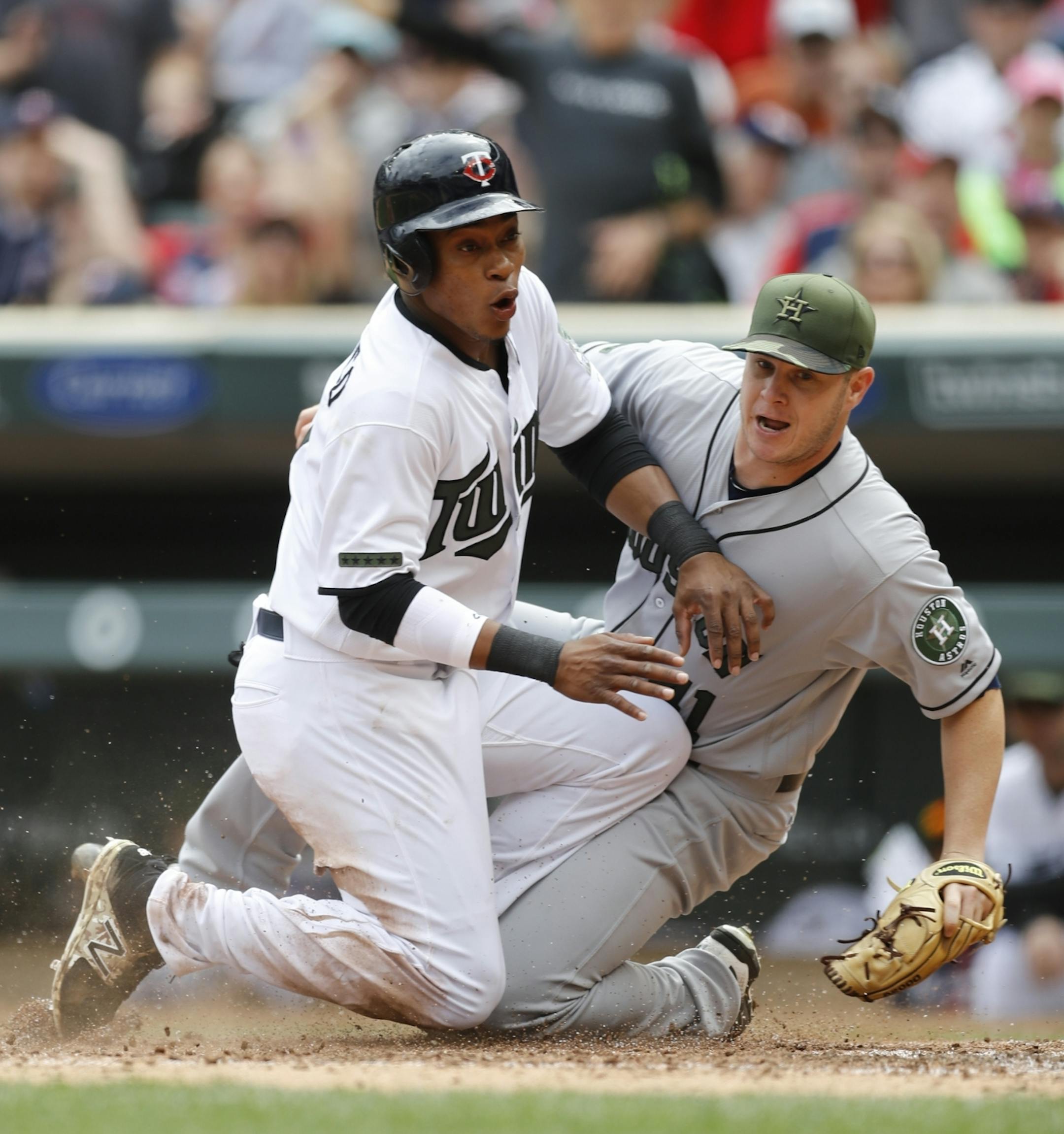Minnesota's Jorge Polanco (11) slide safely to homeplate against Houston pitcher Brad Peacock (41) in the bottom of the fifth inning at Target Field in Minneapolis, Minn. on Monday, May 29, 2017.