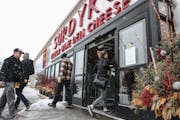 People come to shop in the Surdyk's liquor store in the snow on Sunday. March 12, 2017.
