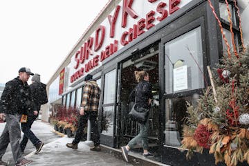 People come to shop in the Surdyk's liquor store in the snow on Sunday. March 12, 2017.