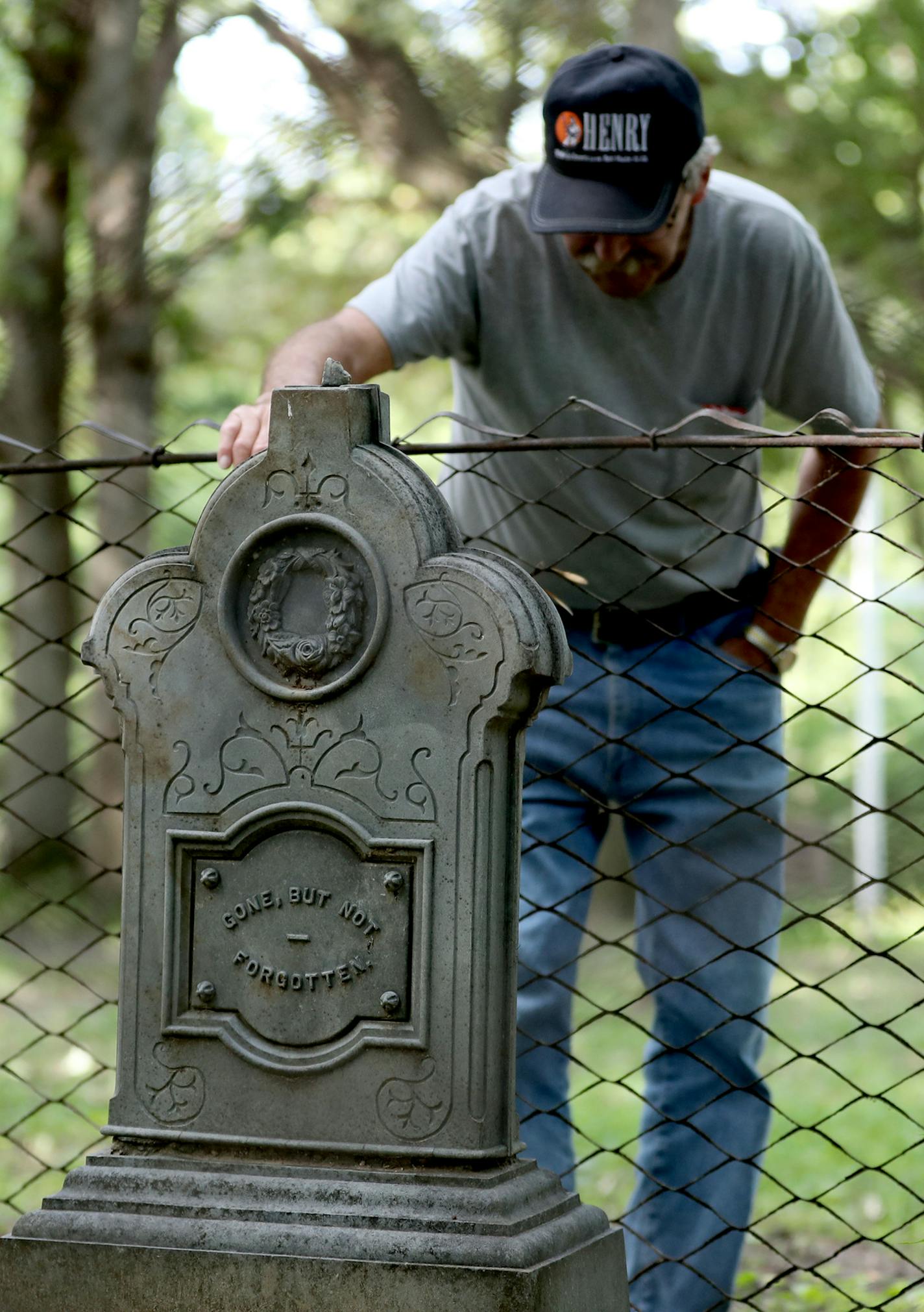 Jim Tafro, 72, has been sprucing up Spring Lake Cemetary, founded in 1861, since early December, despite an upcoming back surgery. Here, Tafro is seen with one of the rare metal grave markers in the cemetery Tuesday, Aug. 23, 2016, in Hastings, MN. Tafro has worked at the cemetery without any pay, seven days a week and has missed just 17 days in 2016--two weeks for a vacation in Arizona and three days in the winter when the weather was bitterly cold. He does it because he believes it is the righ