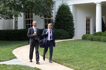 President Obama walks with personal aide Joe Paulsen, a Minnesota native who has been with Obama since the 2007 presidential campaign in Iowa.