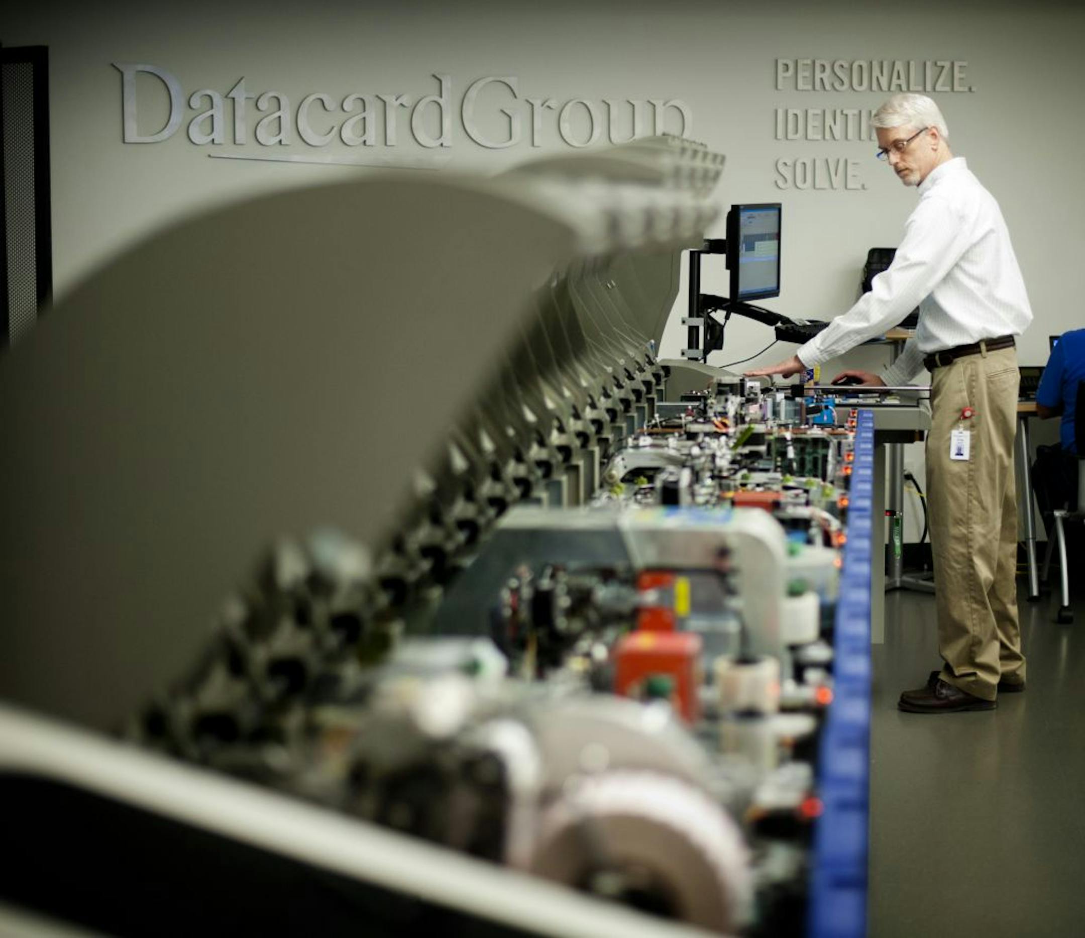 Datacard Group technical support specialist Greg Staler ran tests on a specialty card for an overseas client. Tuesday, April 3, 2012.