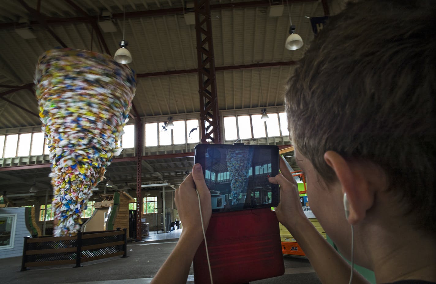 At the Eco Experience Building at the State Fair, Theo Andre,12, films a tornado of plastic bags which are being turned into landscaping products .] Richard Tsong-Taatarii/rtsong-taatarii@startribune.com