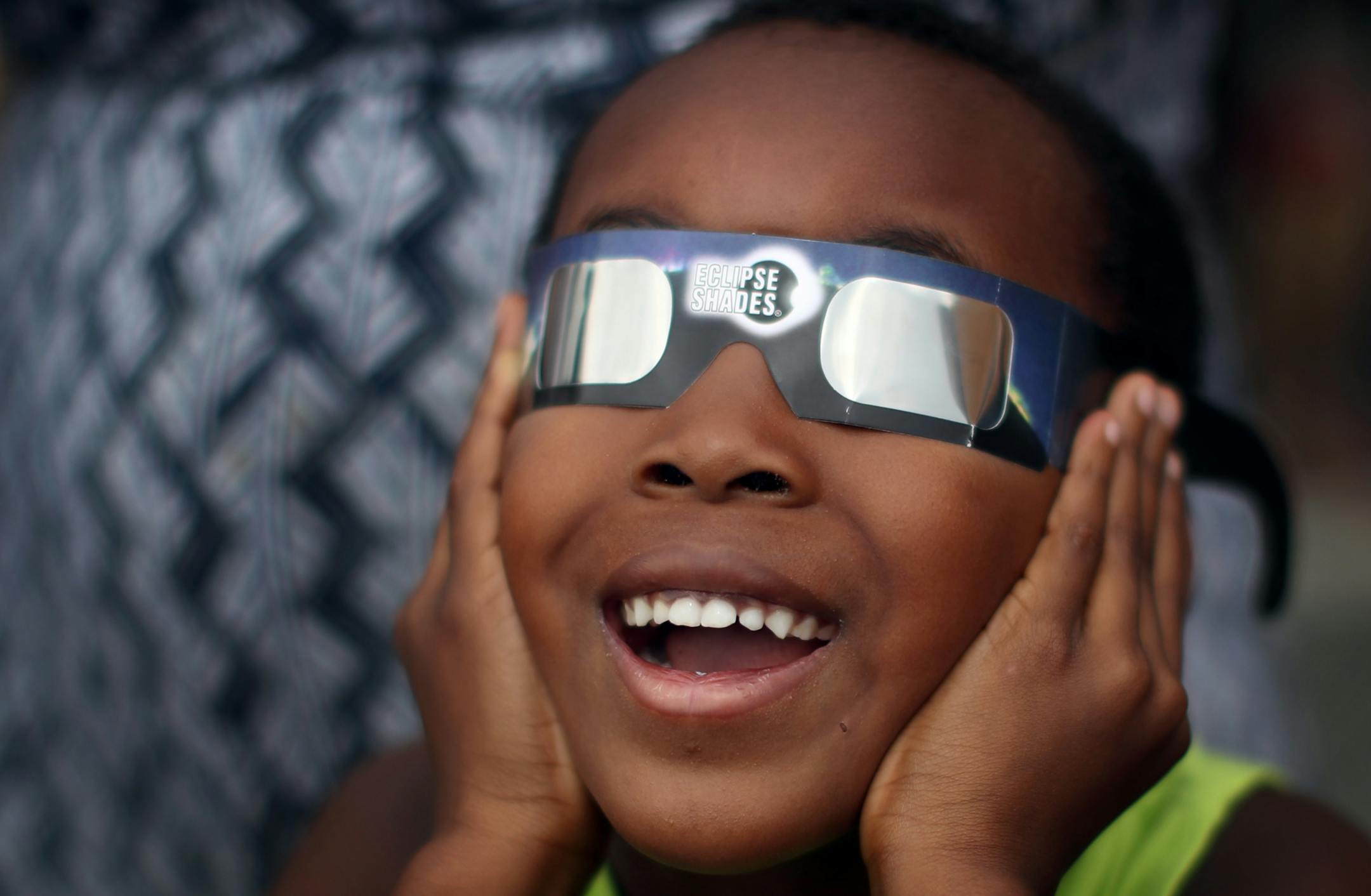 William Ndegwa 7, yelled "I can see it" as he watched a partial eclipse with his mom Maureen Ndegwa at the Science Museum of Minnesota Monday August 21, 2017 in St. Paul, MN.