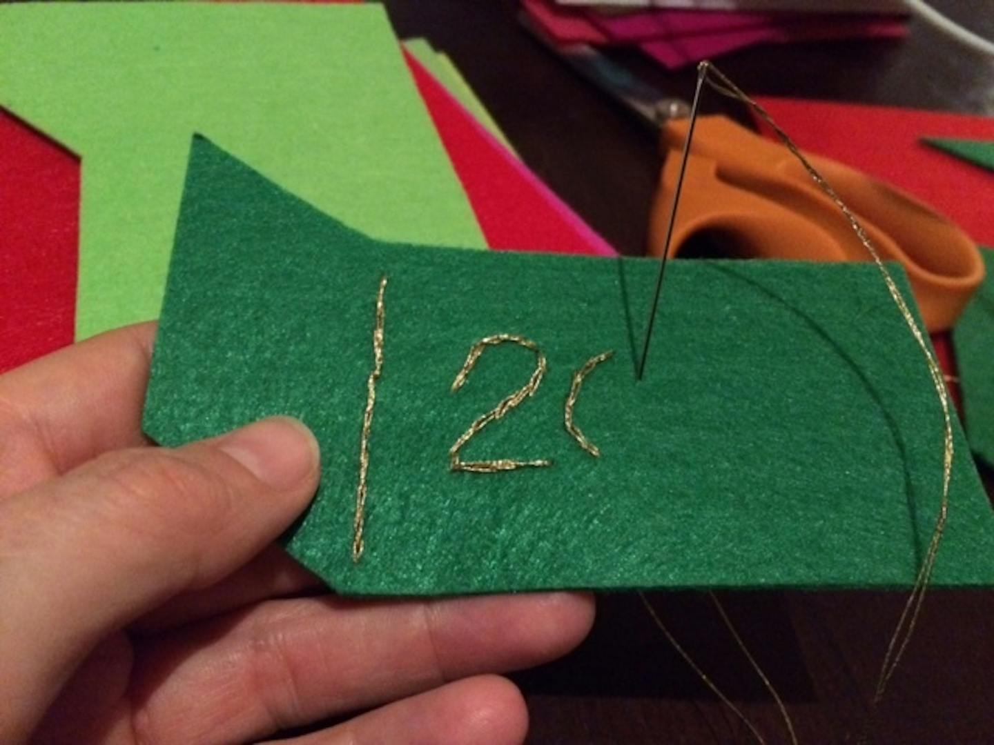 Part of step-by-step instructions for crafting a felt dumpster fire holiday ornament.