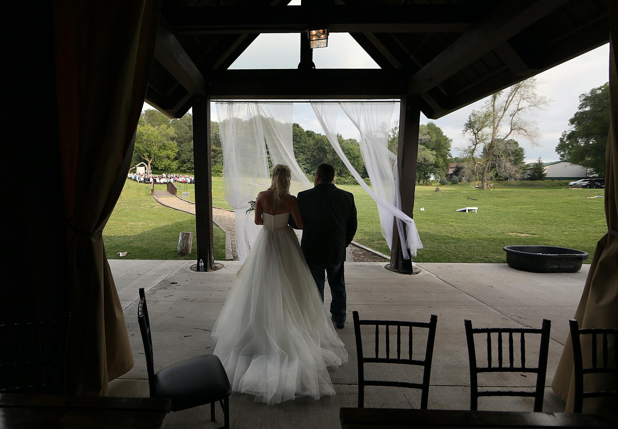 Bride Savannah Koehnen waited with her father, Gary Koehnen, as the two prepared to walk up the aisle.