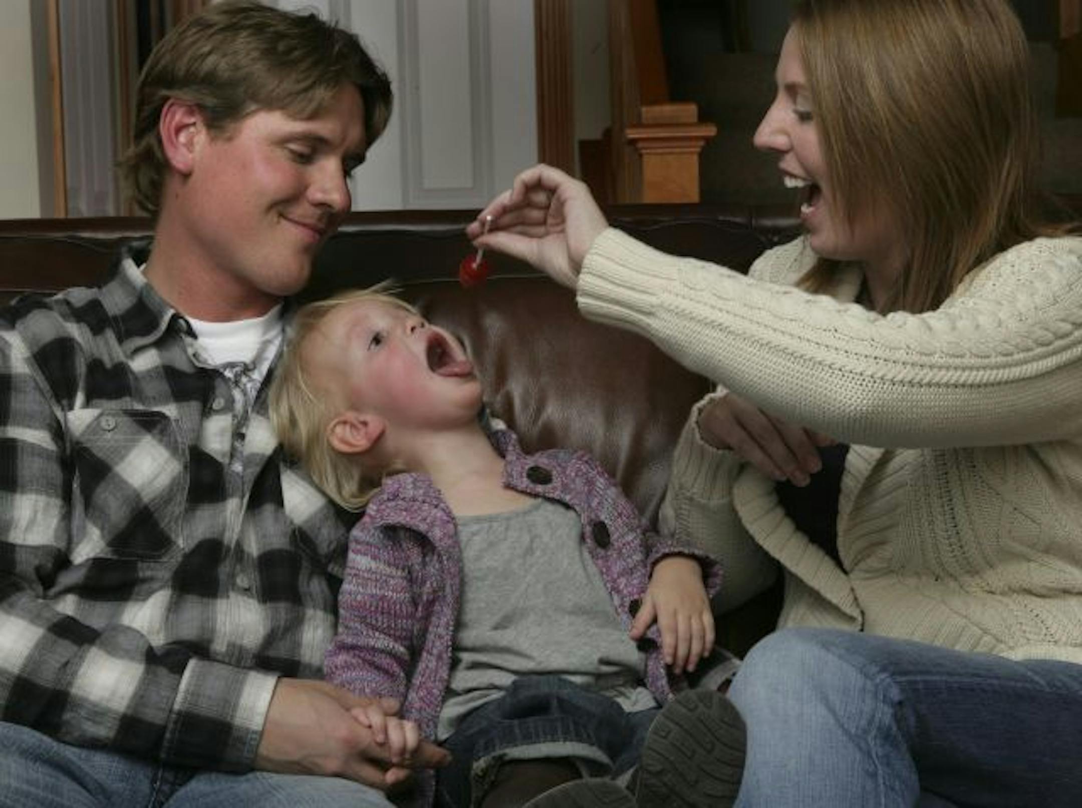 Stacy, left, and Leah Isaak would like to move so their daughter, Evelyn, 2, can grow up closer to her grandmother and other relatives.