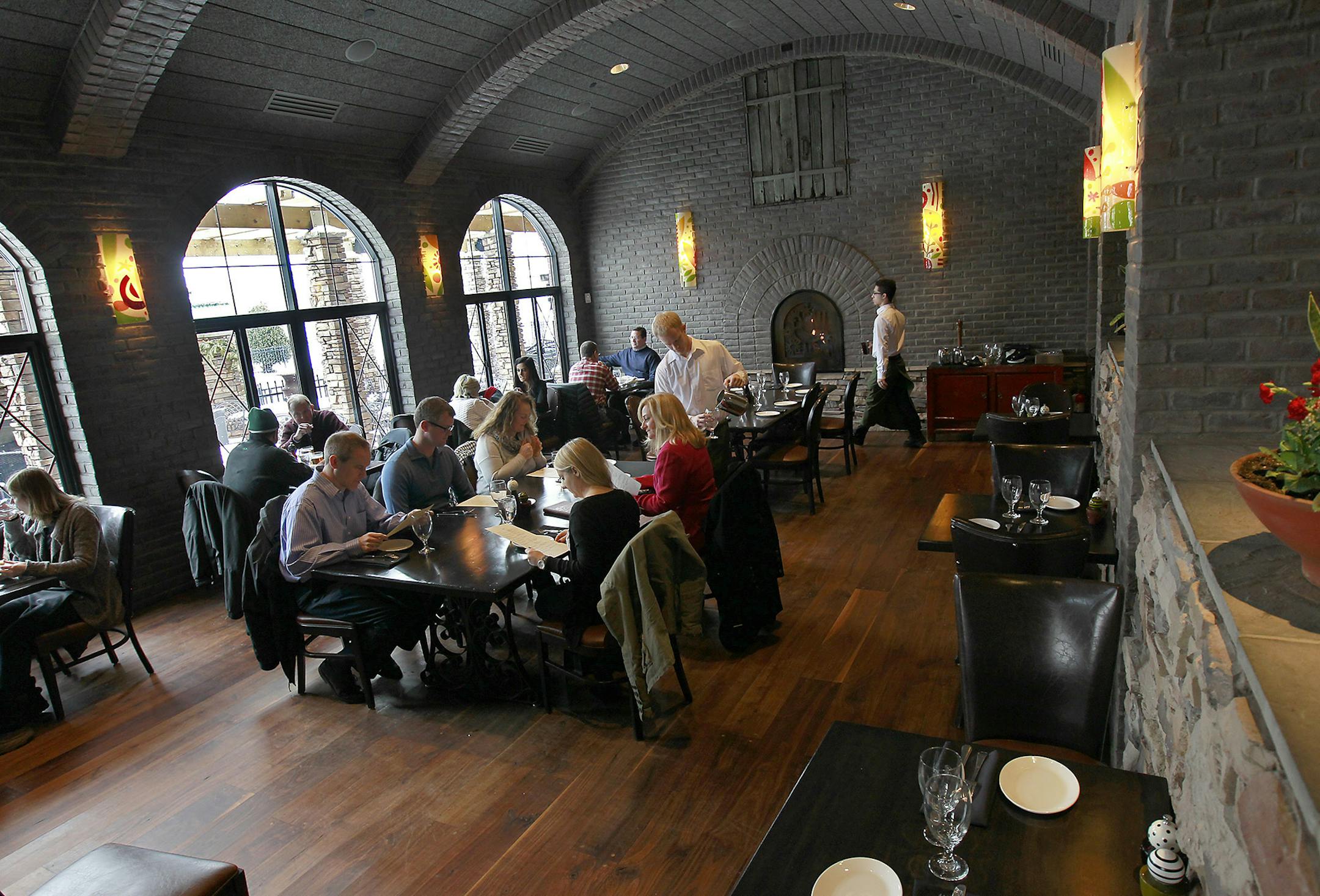 The lunch rush inside one of the dining rooms at Vivo Kitchen. Several fireplaces add a much-needed level of coziness to the sprawling restaurant.