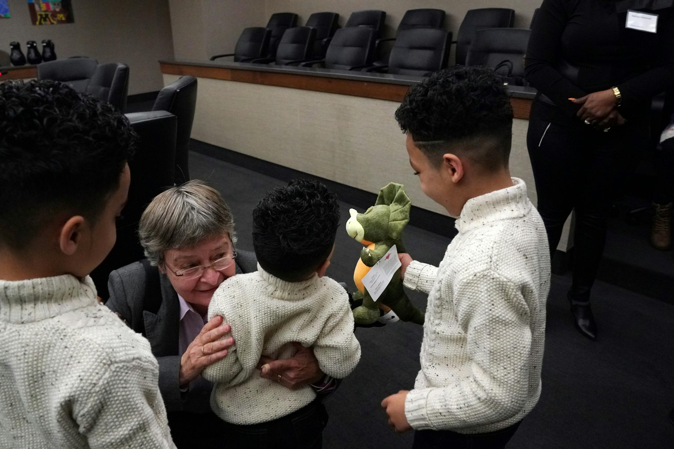 Guardian ad Litem Julie Doherty gave a hug to Tyrees, 4, after he, his two brothers Andre, 8, left, Jameson, 6, right, and sister Natilia, 10, were adopted by their aunt Malinda Gatewood hearing Saturday morning.