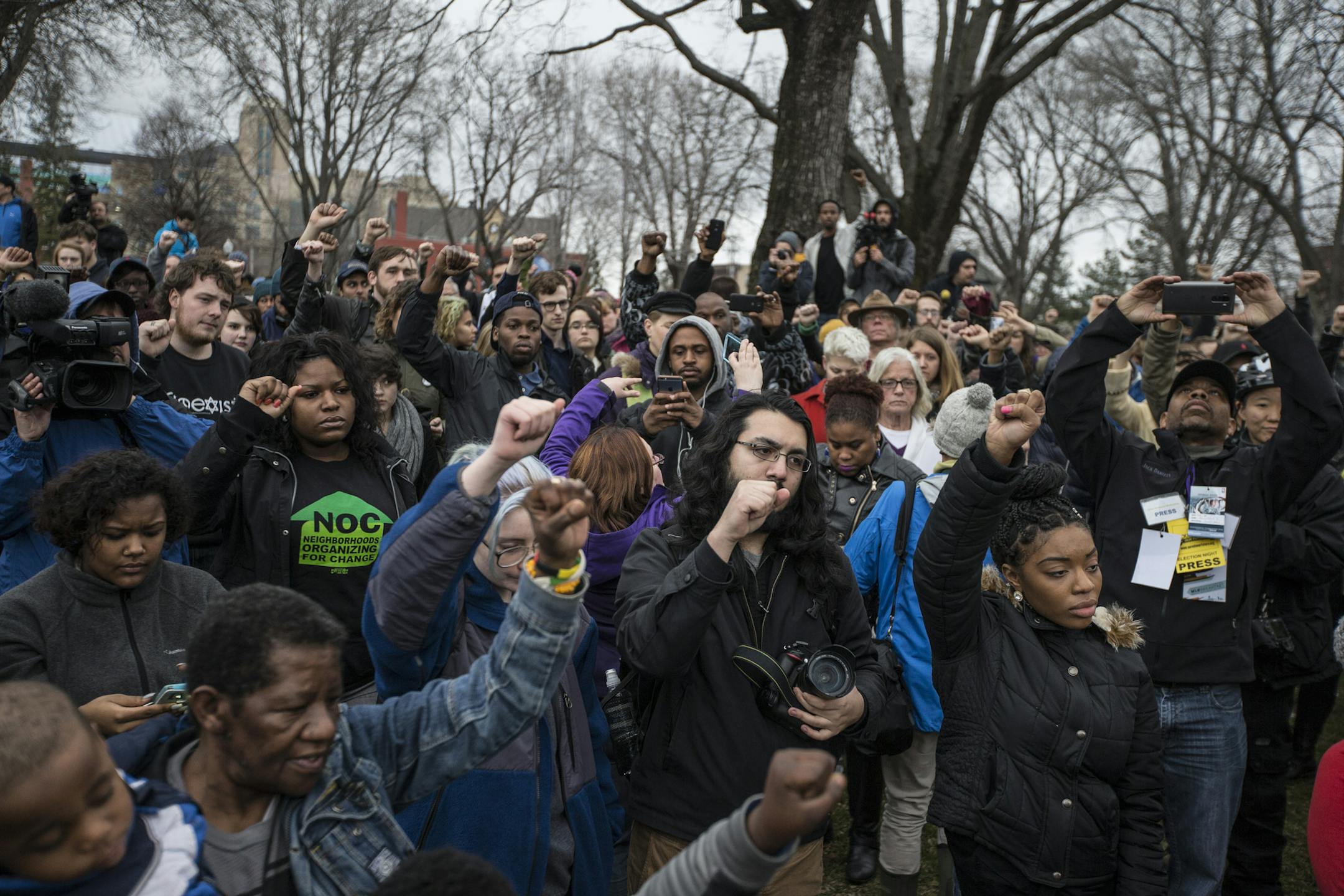 People rallying at Elliot Park raised their fists in the air during a moment of silence.] RENEE JONES SCHNEIDER * reneejones@startribune.com Evening marches and protests began in Minneapolis on Wednesday, March 30, 2016 following the announcement that there will be no charges against Minneapolis police officers in the shooting death of Jamar Clark.