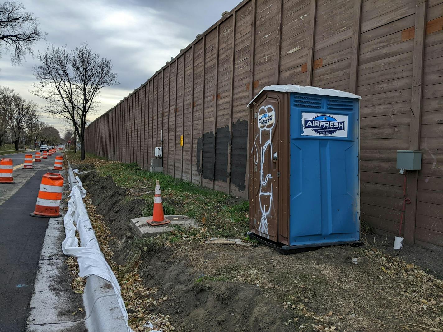 An ouithouse and barrels litter 2nd Avenue S. in Minneapolis between 40th and 42nd streets.