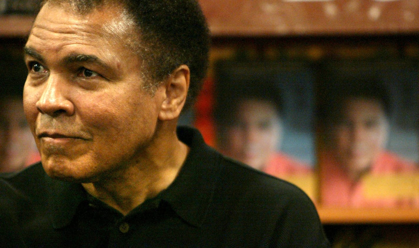 Muhammad Ali listen to fans as he prepares to promote his latest book "The Soul Of A Butterfly," co-authored with his daughter Hana Ali, in Harlem, New York, Wednesday Dec. 1, 2004.