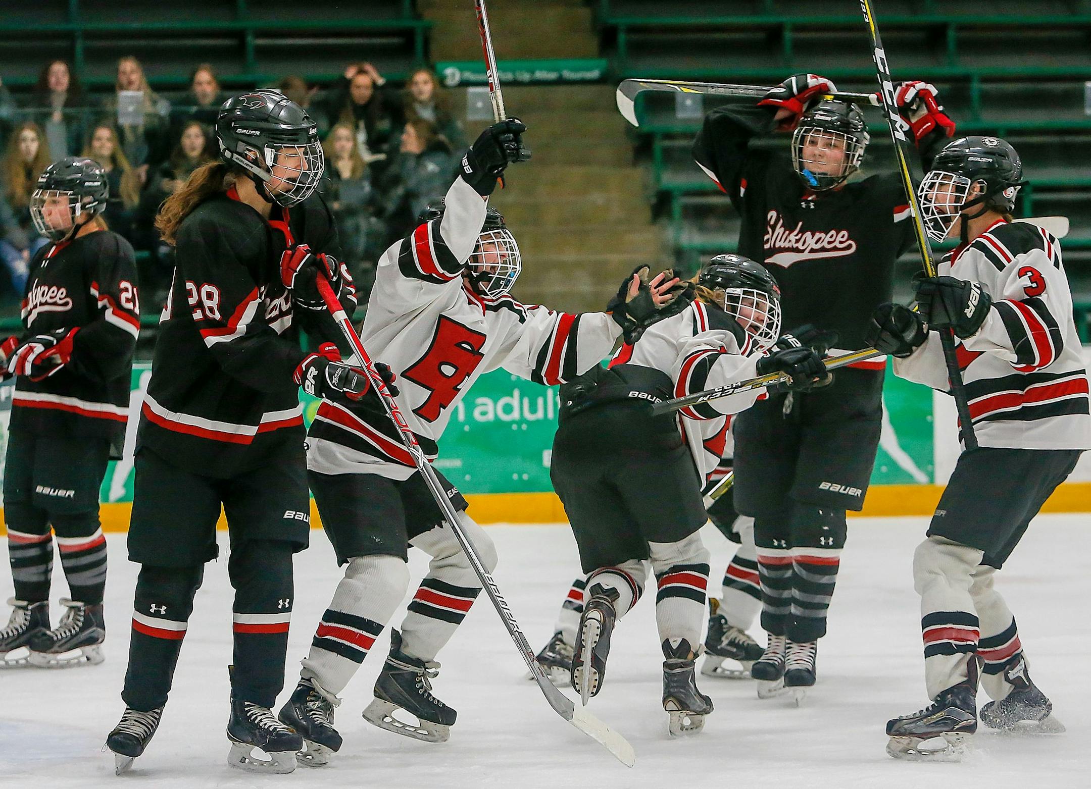 Carrie Byrnes, left, and Grace Kuipers, center, celebrate a first-period goal by Eden Prairie's Sydney Langseth, right, during a Class 2A Section 2 girls hockey final at Braemer Arena in Edina. Langseth scored three goals to give Eden Prairie at 3-0 lead through two periods. Photo by Mark Hvidsten, SportsEngine