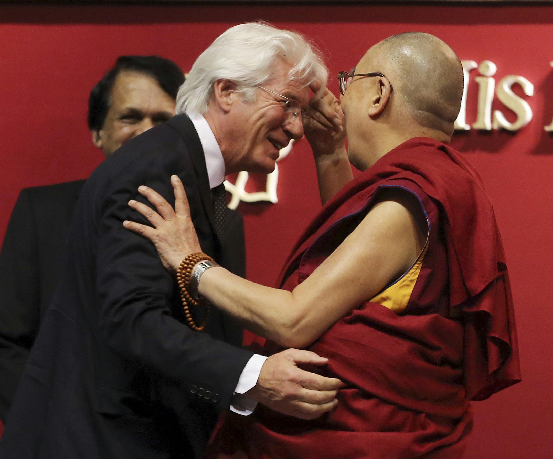 Hollywood actor, activist and philanthropist, Richard Gere, greets Tibetan spiritual leader, the Dalai Lama, during an event at National Institute of Mental Health and Neurosciences in Bangalore, India, Monday, Dec. 7, 2015. (AP Photo/Aijaz Rahi)