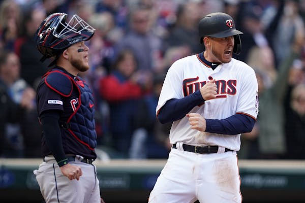 Minnesota Twins first baseman C.J. Cron (24) celebrated after scoring off a two run double hit by left fielder Marwin Gonzalez (9) allowing he and des