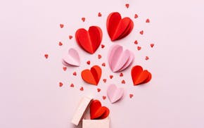 Valentine day composition with gift box and red hearts, photo template on pink background. istock