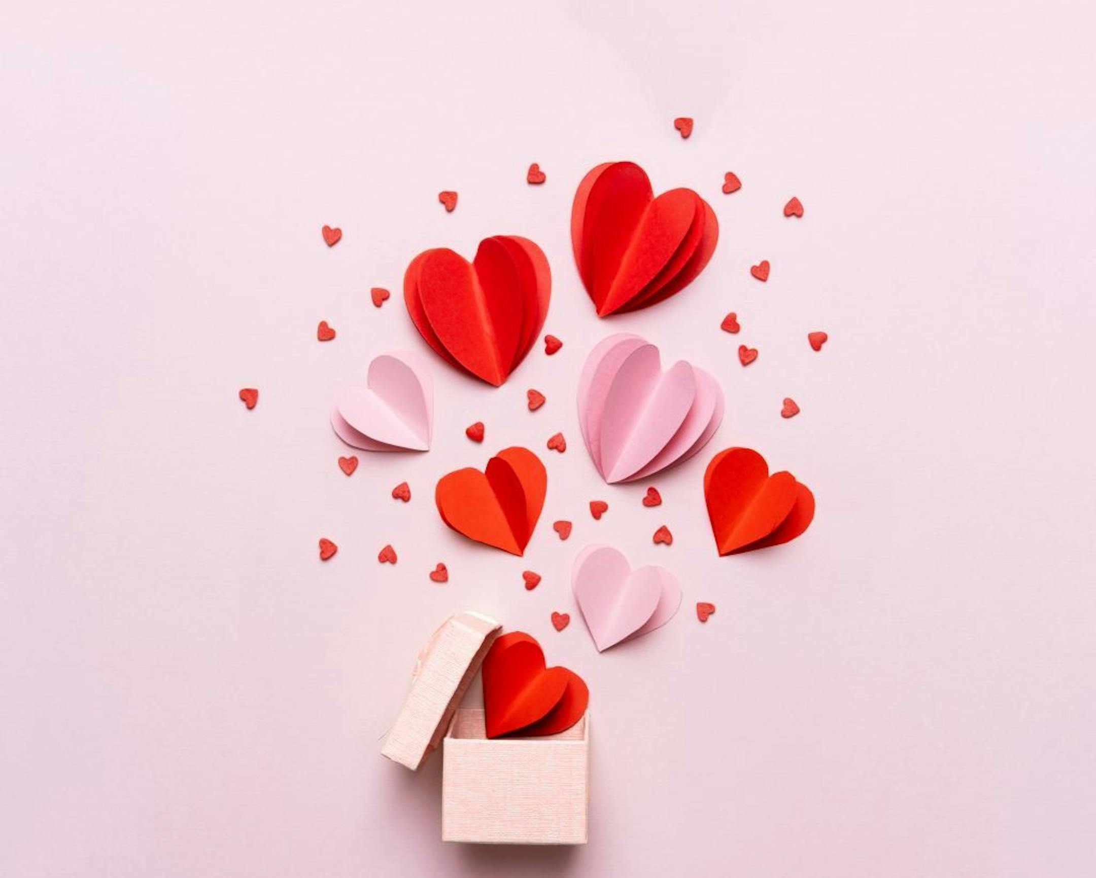Valentine day composition with gift box and red hearts, photo template on pink background. istock