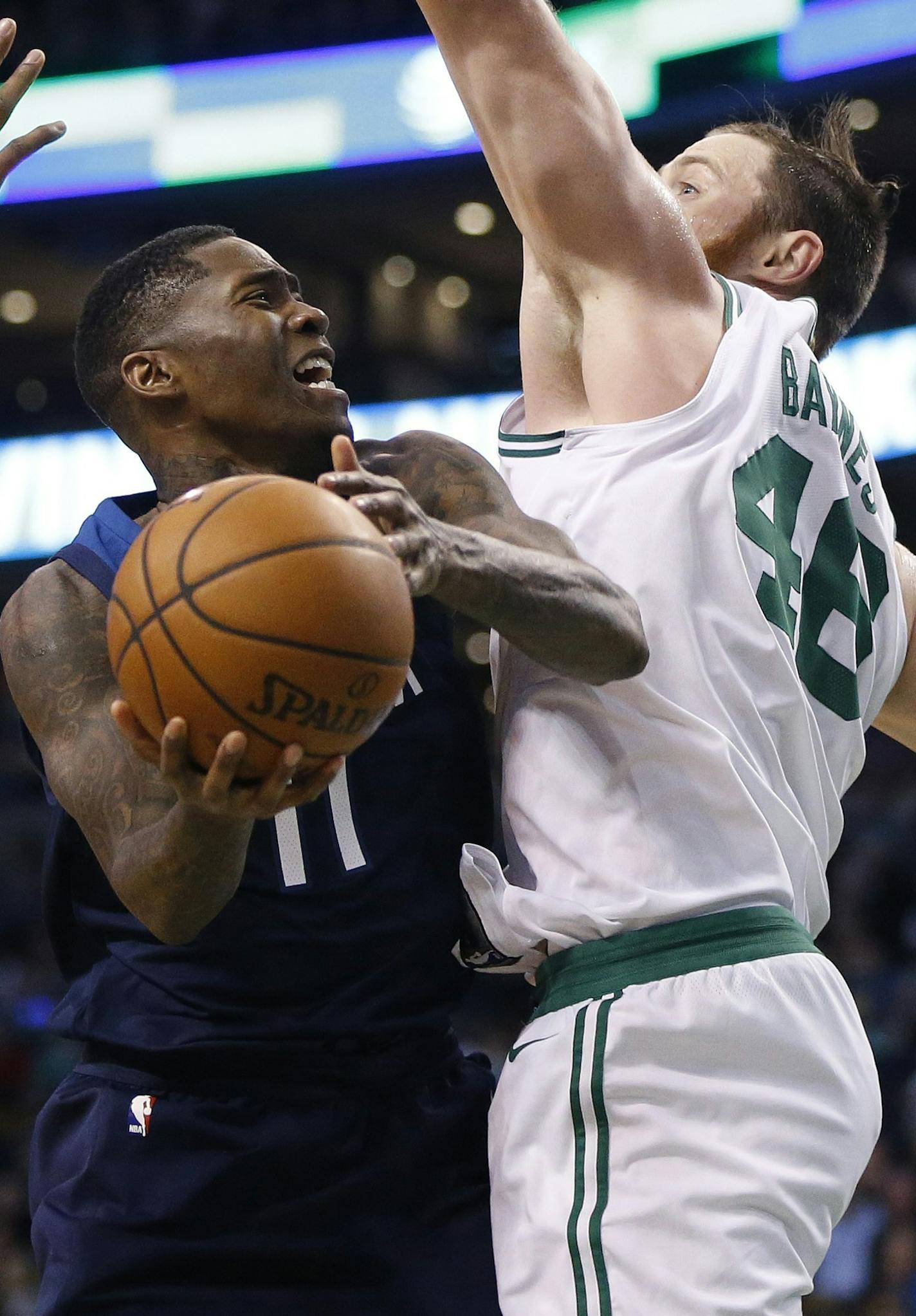 Minnesota Timberwolves' Jamal Crawford (11) goes up to shoot between Boston Celtics' Marcus Smart (36) and Aron Baynes (46) during the fourth quarter of an NBA basketball in Boston, Friday, Jan. 5, 2018. The Celtics won 91-84. (AP Photo/Michael Dwyer)