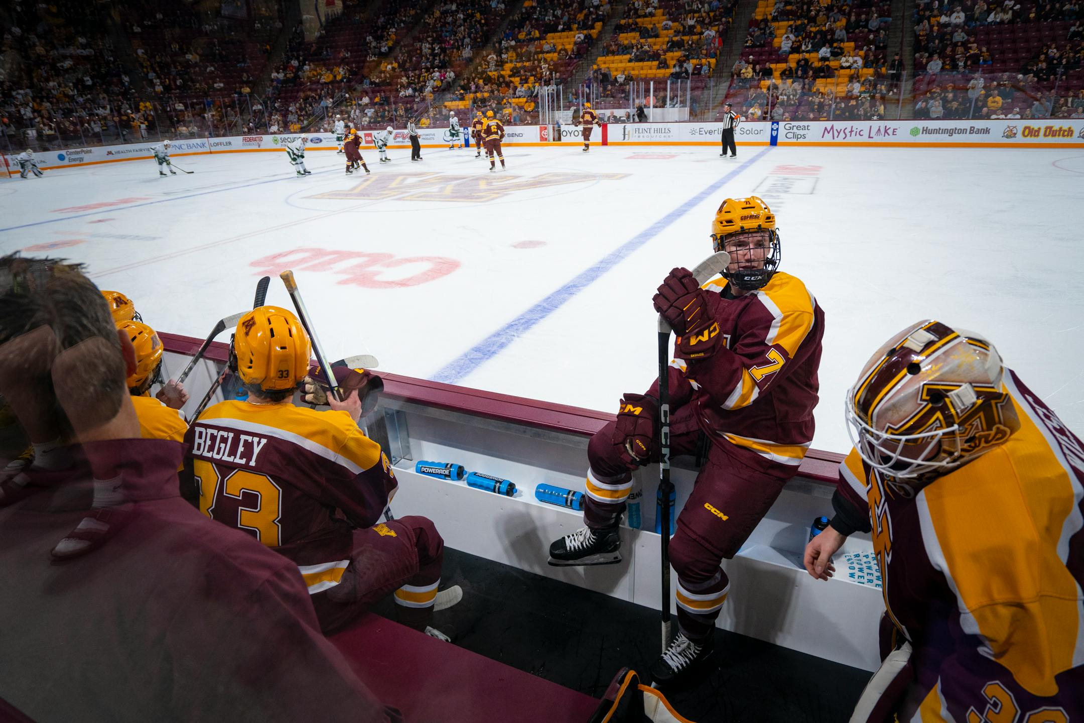 Minnesota's Aaron Huglen (7, Forward) chats with his teammates during the exhibition game against Bemidji State University.