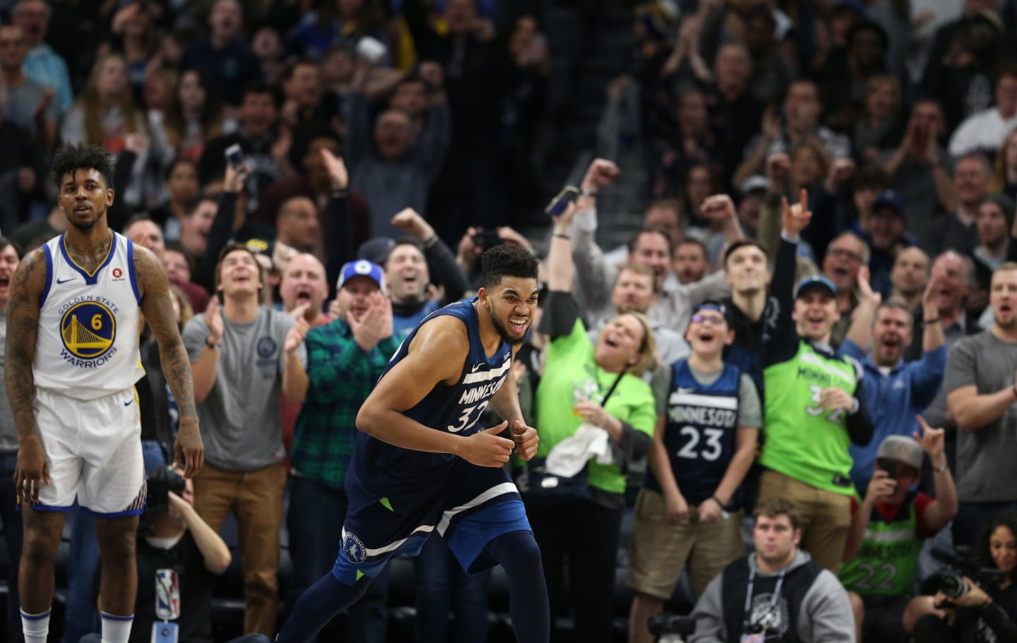 Timberwolves center Karl-Anthony Towns celebrated as Warriors guard Nick Young (6) looked on late in the fourth period of Minnesota's 109-103 victory over defending NBA champion Golde State at Target Center on Sunday.