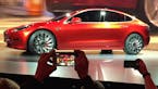 FILE - In this March 31, 2016 file photo, Tesla Motors unveils the new lower-priced Model 3 sedan at the Tesla Motors design studio in Hawthorne, Cali
