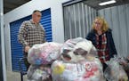 Anthony Deveaux and Laurie Fulgham stacked bags of stuffed animals onto a cart Saturday at All Climate Self Storage in Rochester.