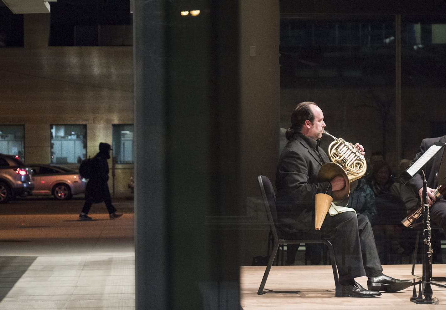 A passerby strolled down 11th Street as Minnesota Orchestra horn player Bruce Hudson &#x2014; visible through the floor-to-ceiling windows of Target Atrium &#x2014; performed in a recent NightCap concert.