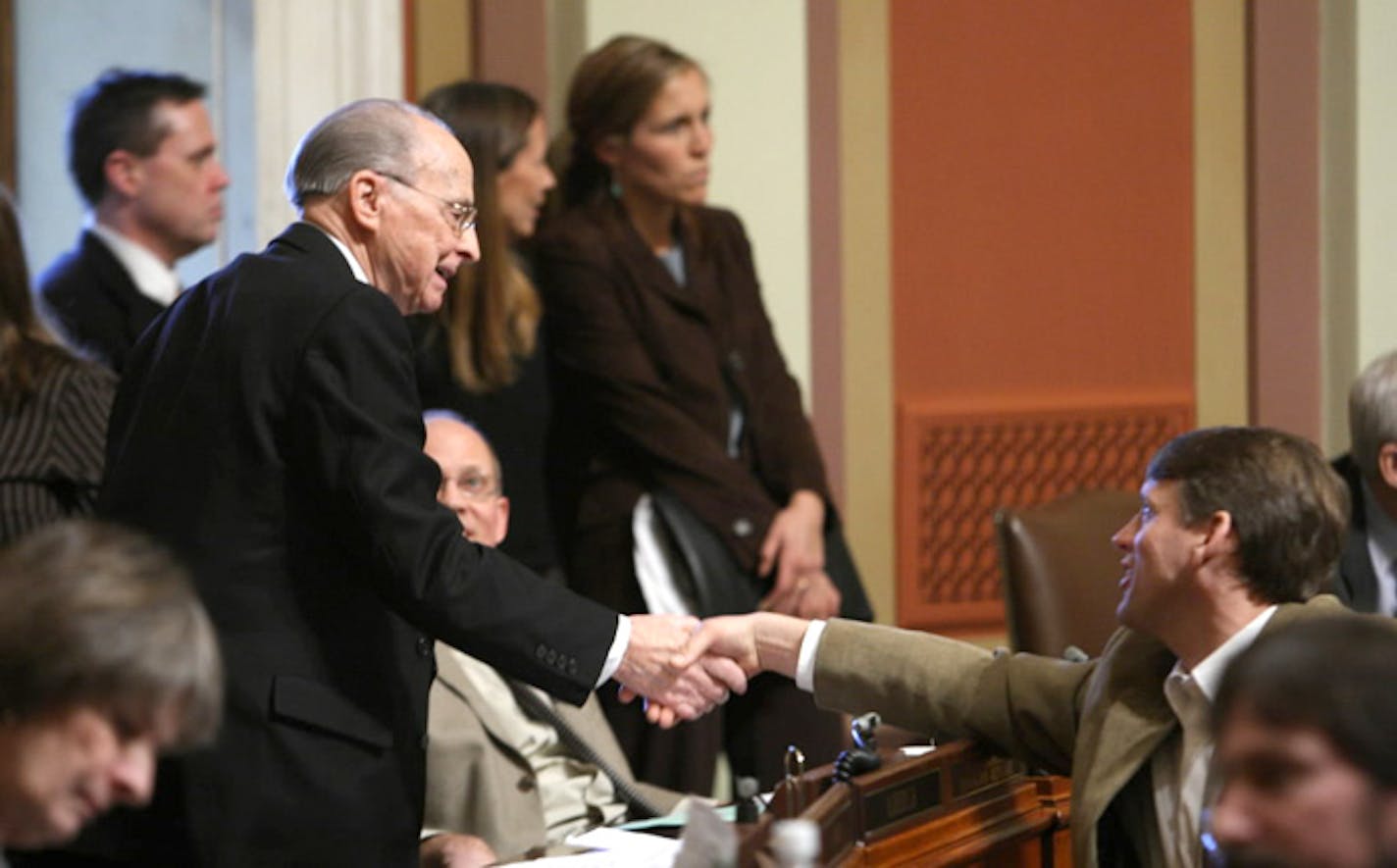 Rep. Bernie Lieder, DFL-Crookston, author of the bill to override Gov. Tim Pawlenty's veto of the transportation bill, is congratulated by Frank Moe of Bemidji, right, moments after the vote.