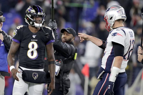 Baltimore Ravens quarterback Lamar Jackson (8) talks with New England Patriots quarterback Tom Brady prior to an NFL football game, Sunday, Nov. 3, 20