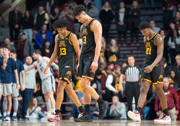 Gophers forwards Jaden Henley (13), Dawson Garcia (3) and Pharrel Payne (21) trudged off the court after losing to Penn State 76-69 Saturday.