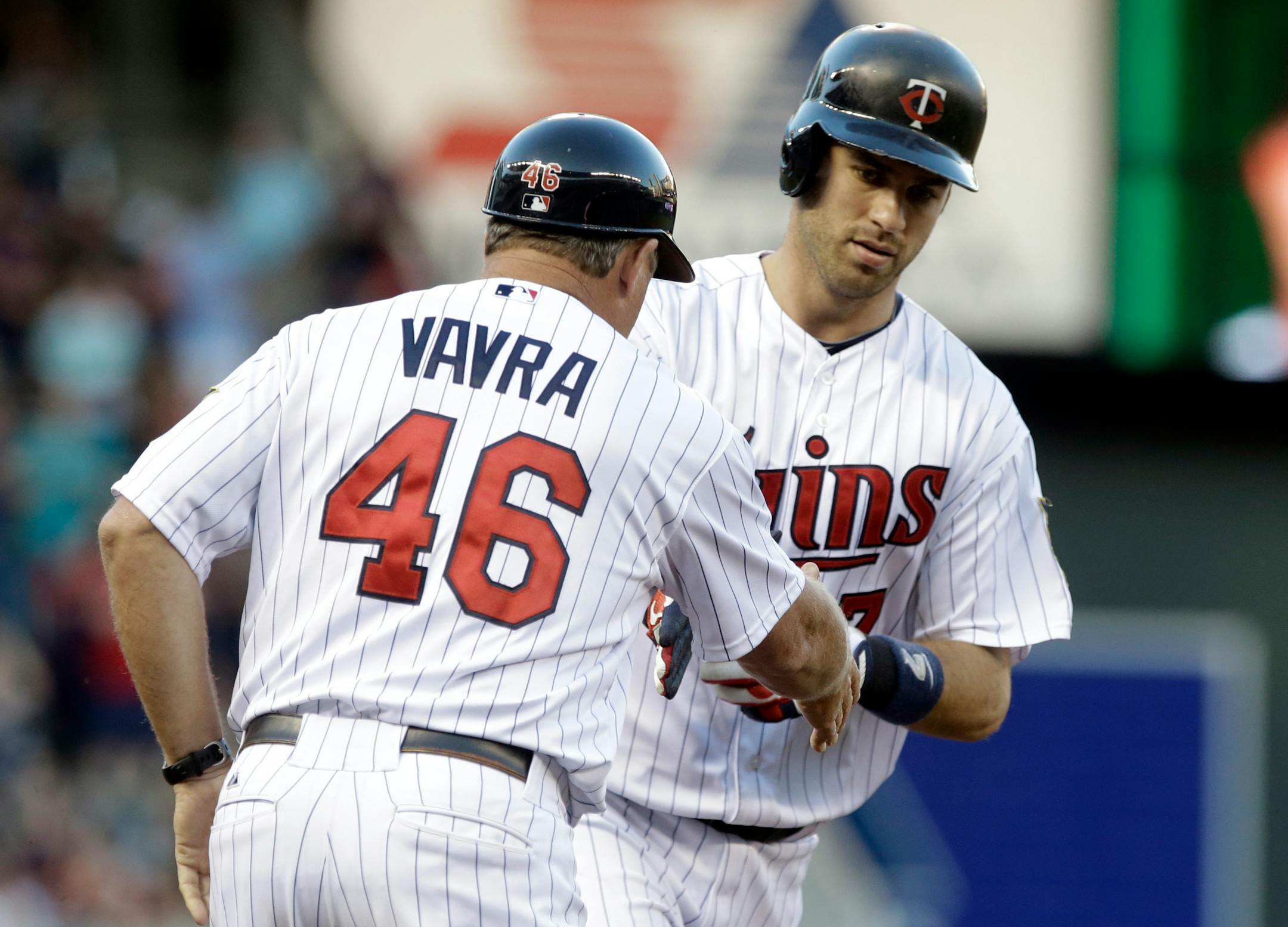 Minnesota Twins third base coach Joe Vavra congratulates Joe Mauer, right, on his solo home run off Chicago White Sox pitcher Jose Quintana in the first inning of a game Aug. 16. Mauer has not played since Aug. 20.