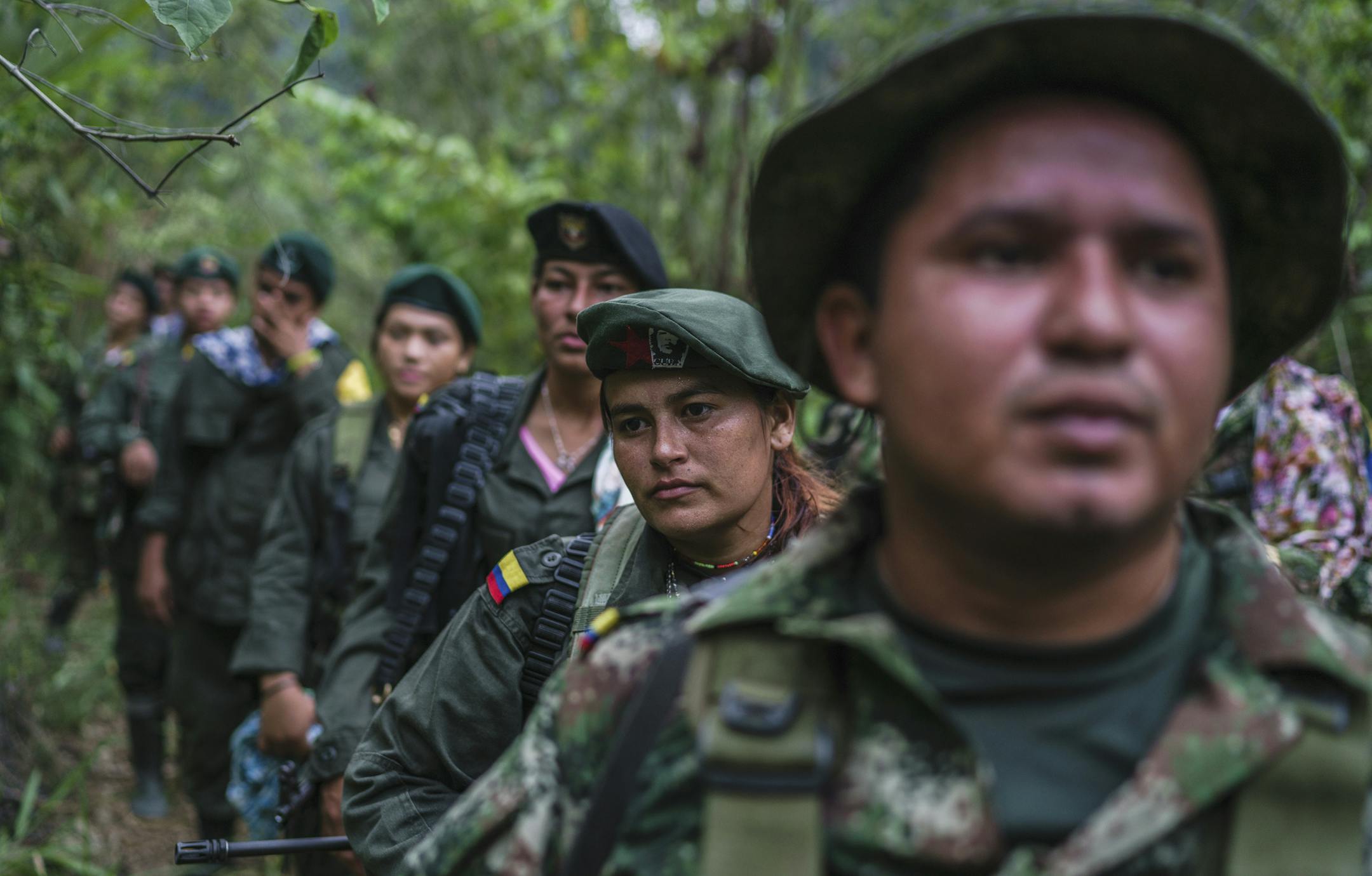 FILE -- Members of the Revolutionary Armed Forces of Colombia, or FARC, walk in formation to reach a small village near their camp in the mountains of Colombia in March, 2016. Colombiaís government and FARC, the largest rebel group in the country, have reached a deal to end more than 50 years of conflict, the two sides announced on Aug. 24, paving the way for an end to the longest running war in the Americas. (Federico Rios/The New York Times)