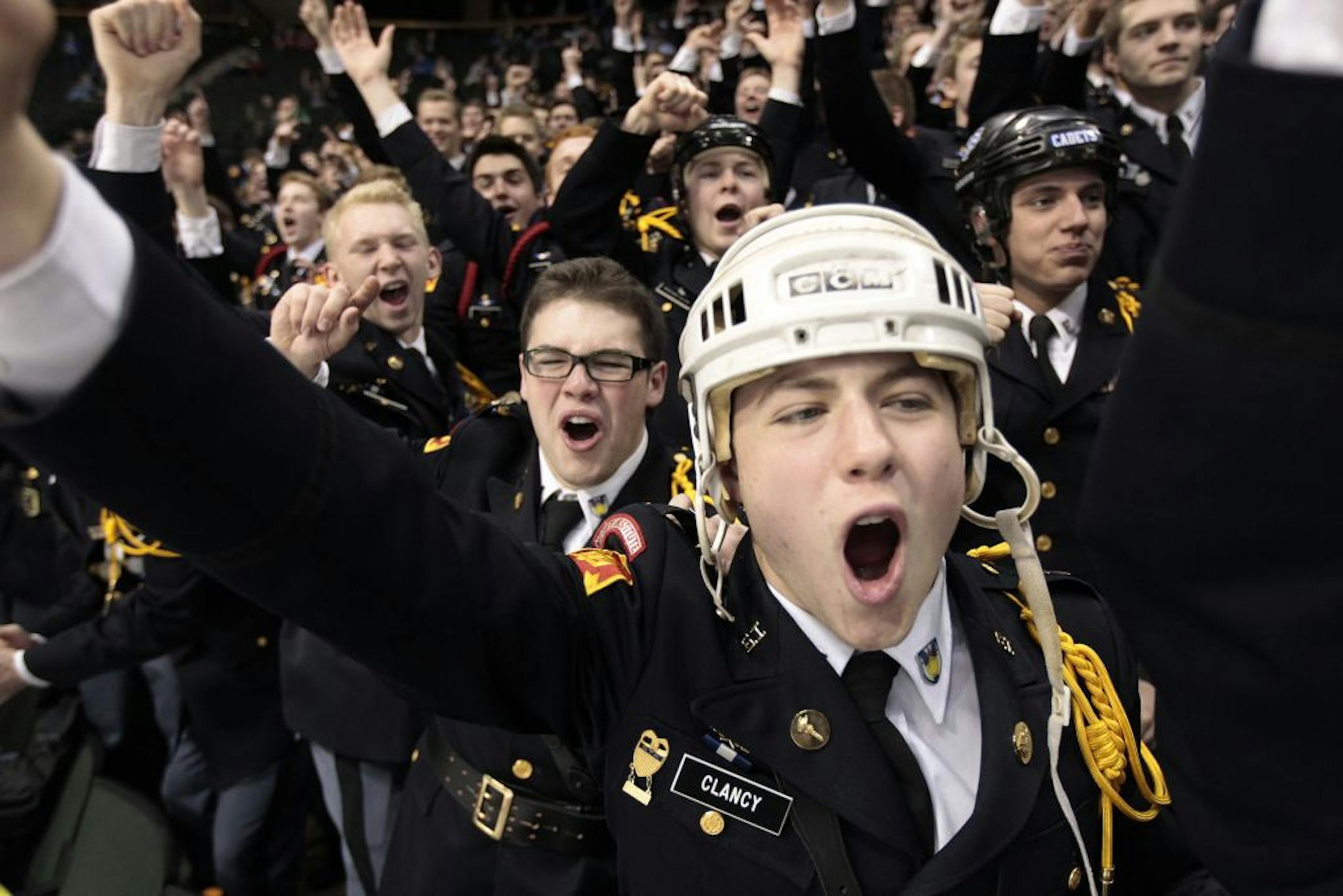 Paddy Clancy of St. Thomas Academy and fellow Cadets cheered as their team scored against Little Falls in state hockey tournament Wednesday.