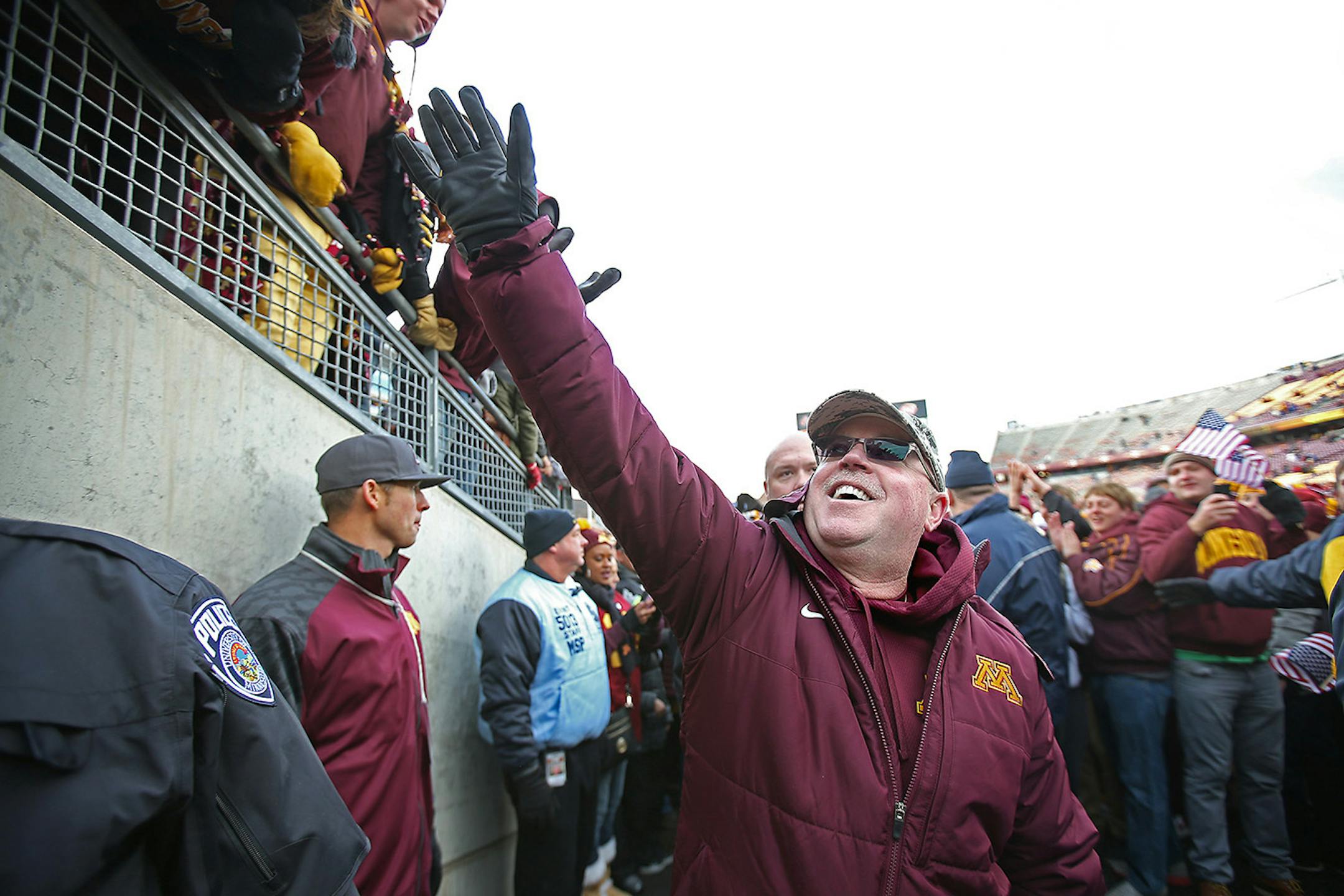 Minnesota's head coach Jerry Kill was greeted after the Gophers defeated the Iowa Hawkeyes 51-14, Saturday, November 8, 2014 at TCF Bank Stadium in Minneapolis.