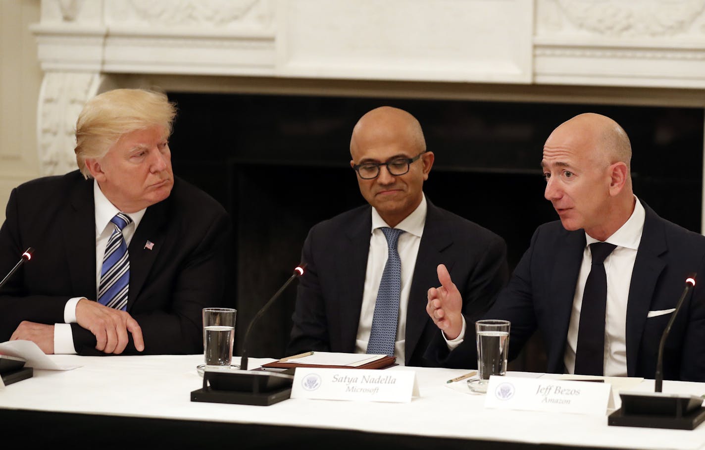 President Donald Trump, left, sat with Microsoft CEO Satya Nadella, center, and Amazon CEO Jeff Bezos in a June meeting.