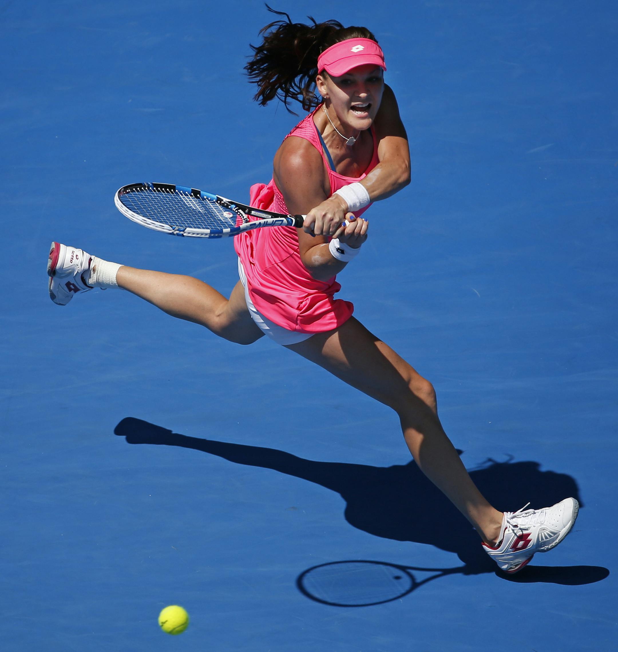Agnieszka Radwanska of Poland makes a backhand return to Carla Suarez Navarro of Spain during their quarterfinal match at the Australian Open tennis championships in Melbourne, Australia, Tuesday, Jan. 26, 2016.(AP Photo/Vincent Thian)