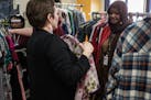 Vice Principal Lisa Purcell shows a blouse option to Rabia Ibrahim, 17, a junior, at the free thrift store at Roosevelt High School in Minneapolis.