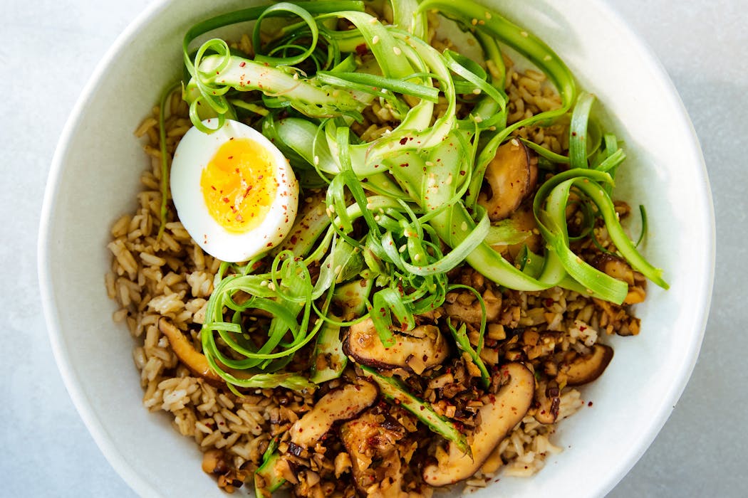 A gingery mix of mushrooms and asparagus provides the topping for this grain bowl from Melissa Clark.