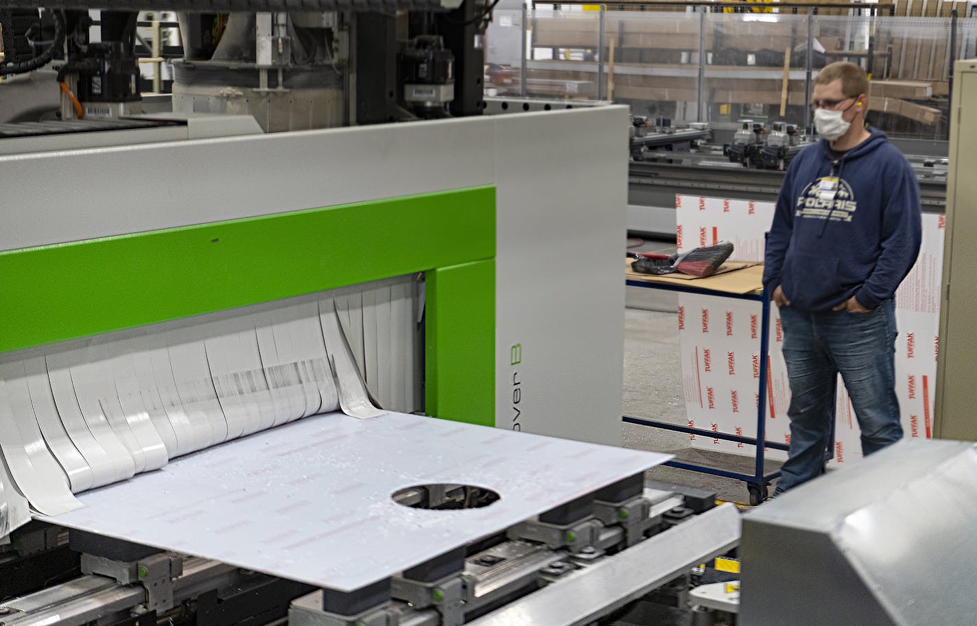 Kyle Hinkle is helping to make polycarbonate boxes to help shield health professionals during sugical procedures at Marvin Windows' Warroad factory. (Provided by Marvin)