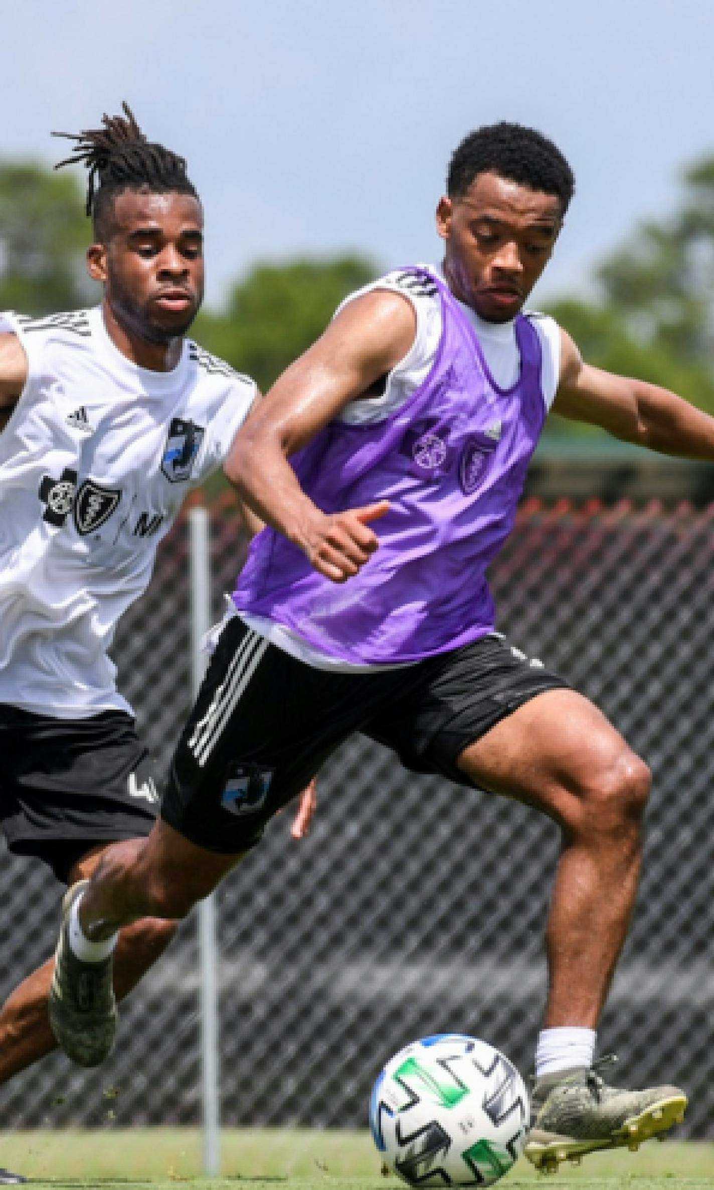 Jacori Hayes controlling the ball with Raheem Edwards defending from behind. Both are new midfielders acquired for this season. They're training at ESPN Wide World of Sports Complex at Walt Disney World in Orlando.