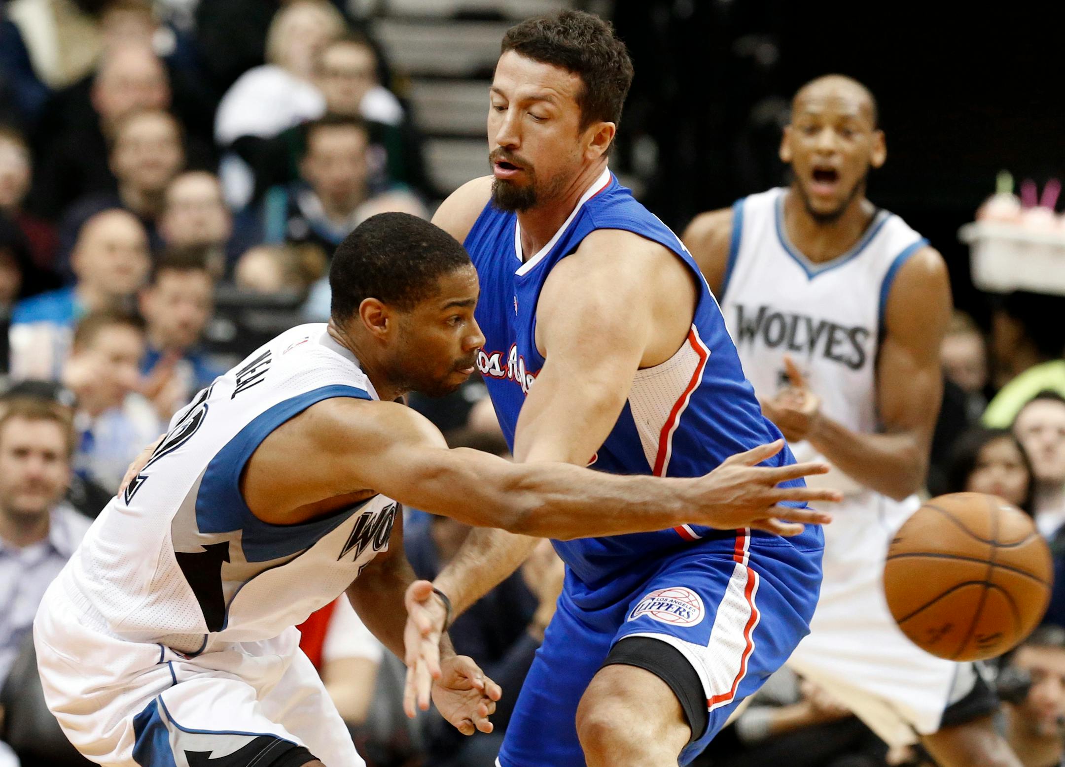 Gary Neal passes the ball around Los Angeles Clippers' Hedo Turkoglu during the second half of an NBA basketball game, Monday, March 2, 2015, in Minneapolis.