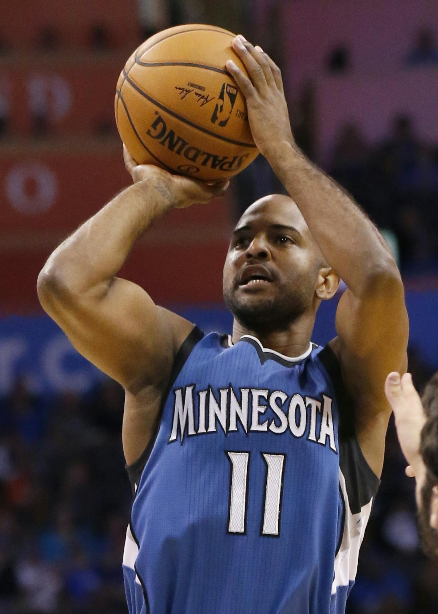 Minnesota Timberwolves guard John Lucas III (11) shoots in front of Oklahoma City Thunder guard Alex Abrines, right, in the first quarter of an NBA basketball preseason game in Oklahoma City, Sunday, Oct. 16, 2016. (AP Photo/Sue Ogrocki) ORG XMIT: MIN2016101619490624